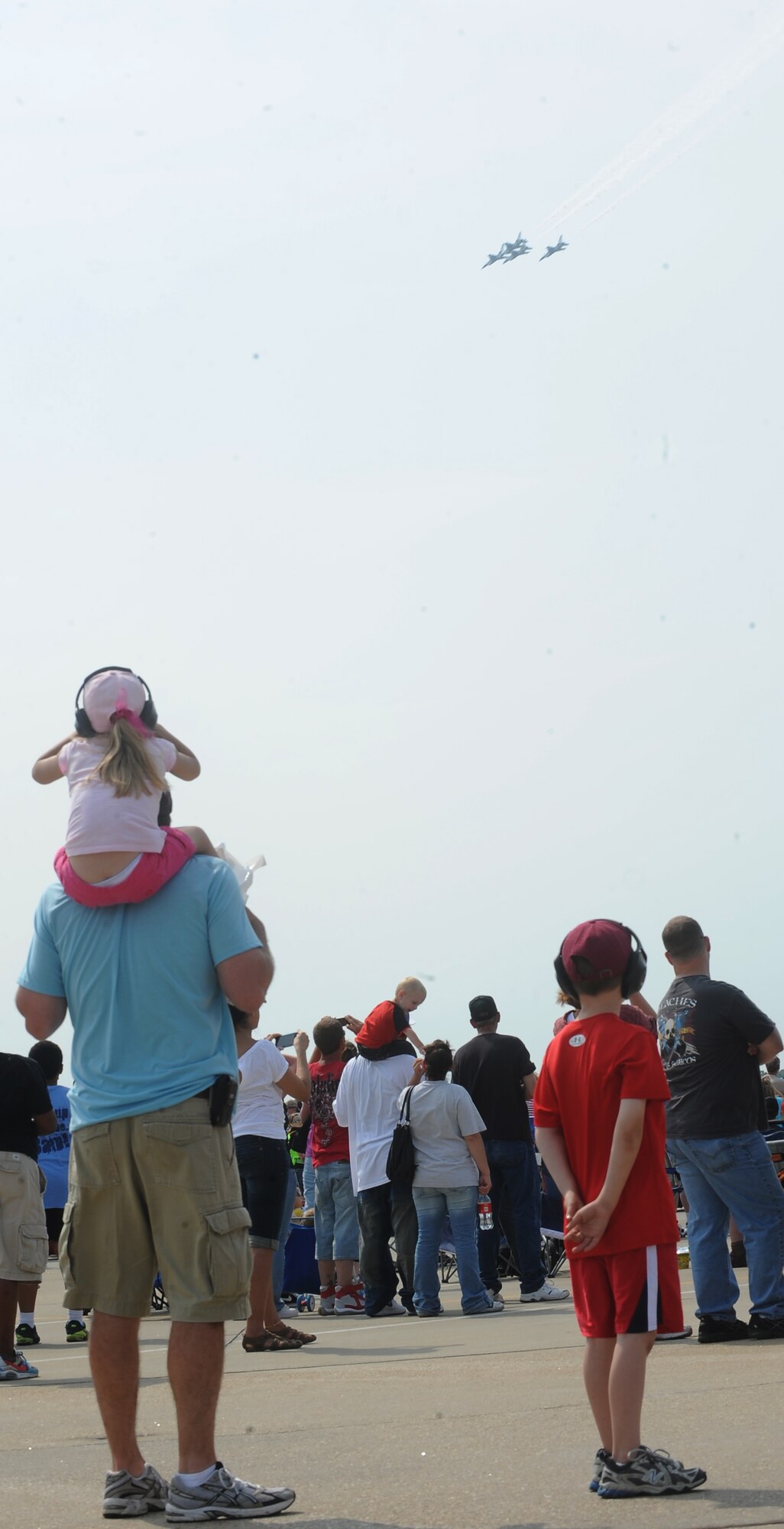 Spectators watch the Thunderbirds' demonstration during the Air Power over Hampton Roads Open House at Langley Air Force Base, Va., May 14, 2011. The Joint Base Langley-Eustis open house is a free three-day event featuring a variety of aerial demonstrations, including historical aircraft and the United States Air Force Demonstration Squadron, the Thunderbirds. (U.S. Air Force photo by Senior Airman Antoinette Gibson) (RELEASED)