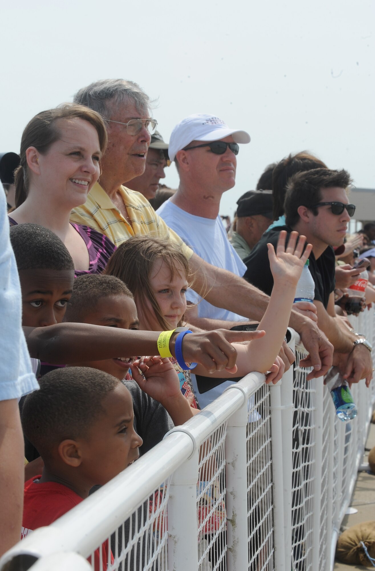 Spectators watch the Thunderbirds' demonstration during the Air Power over Hampton Roads Open House at Langley Air Force Base, Va., May 14, 2011. The Joint Base Langley-Eustis open house is a free three-day event featuring a variety of aerial demonstrations, including historical aircraft and the United States Air Force Demonstration Squadron, the Thunderbirds. (U.S. Air Force photo by Senior Airman Antoinette Gibson) (RELEASED)