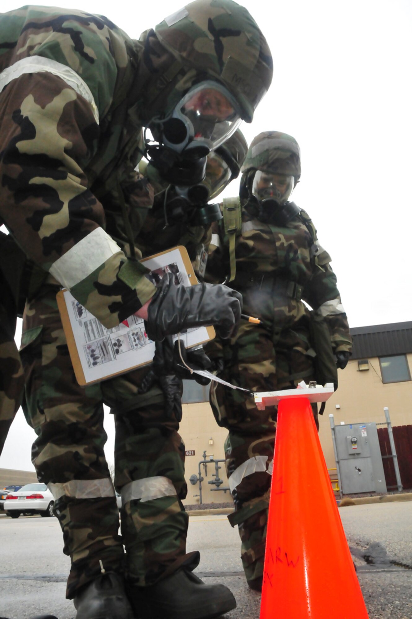 An Airmen assigned to the 128th Air Refueling Wing, Milwaukee, monitors chemical-detection paper during a mock-attack during an Ability to Survive and Operate exercise at Gen. Mitchell International Airport on Saturday, May 14, 2011. The ATSO exercise tested the readiness and preparedness of Airmen to survive and operate during chemical, nuclear, and biological attacks. U.S. Air Force photo by Tech Sgt. Thomas J Sobczyk  / Released