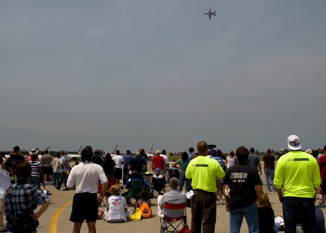 Spectators watch as an A-10 Thunderbolt II performs during AirPower over Hampton Roads May 14, 2011. The annual open house provides a free venue in which the public can see modern and historical military aircraft and civilian performers in action. (U.S. Air Force photo/Senior Airman Zachary Wolf)(RELEASED)