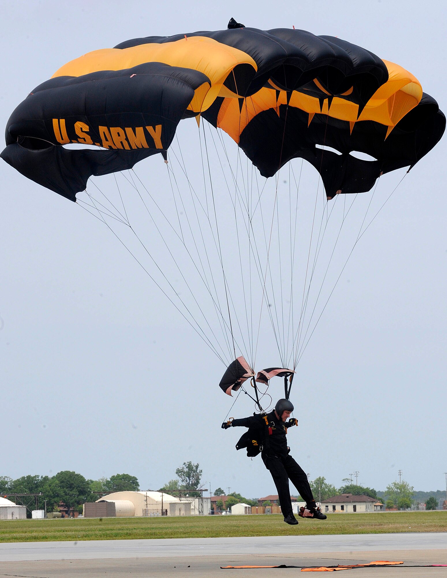 A parachutist with the U.S. Army Golden Knights Parachute Team touches down after completing an aerial jump during the AirPower over Hampton Roads open house at Langley Air Force Base, Va., May 14, 2011. The Golden Knights have been wowing audiences at air shows, competitions, and high-profile tandems for 50 years. (U.S. Air Force photo by Staff Sgt. Dana Hill)(RELEASED)