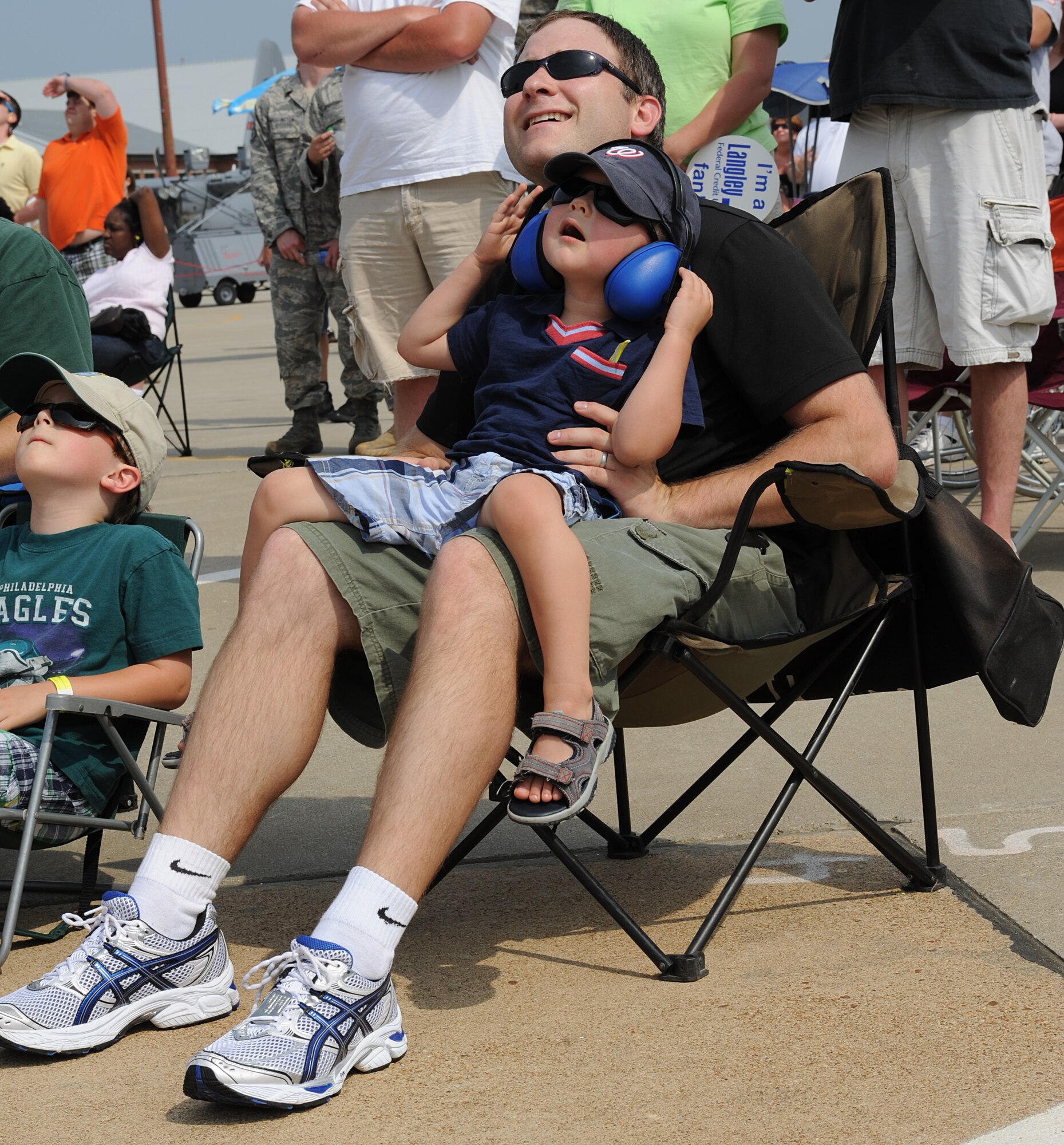 Jeramiah Hayes and his son Andrew, age 2, watch the U.S. Air Force Demonstration Squadron, Thunderbirds, during Joint Base Langley Eustis’ Air Power over Hampton Roads Open House at Langley Air Force Base, Va., May 14, 2011. The Thunderbirds headlined the open house with precision aerial maneuvers, demonstrating the capabilities of high performance aircraft to the Hampton Roads area. (U.S. Air Force photo/Airman 1st Class Teresa Zimmerman)(RELEASED)