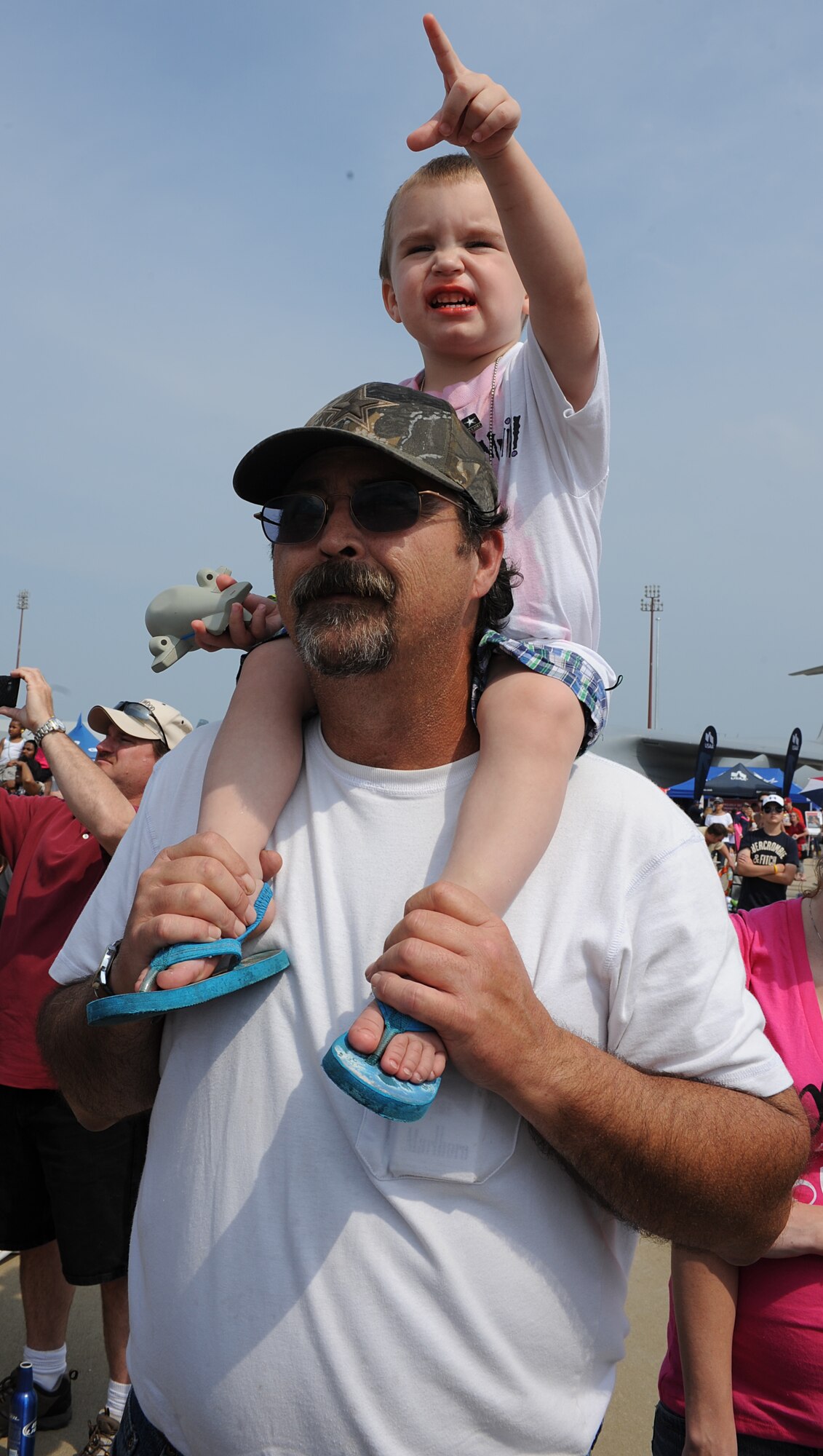 Dylan Pledger, age 2, sits on John Kramer’s shoulders and points toward the U.S. Air Force Demonstration Squadron, Thunderbirds, during Joint Base Langley Eustis’ Air Power over Hampton Roads Open House at Langley Air Force Base, Va., May 14, 2011. The open house helps to educate the public about Air Force capabilities and shows appreciation to the local community.  (U.S. Air Force photo/Airman 1st Class Teresa Zimmerman)(RELEASED)