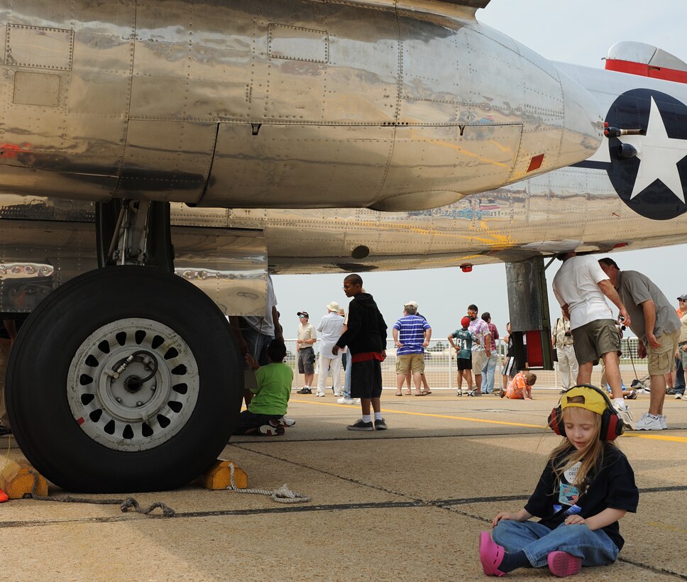 Nichole Shockley, age 5, rests under the wing of B-25 “Panchito”, during Joint Base Langley Eustis’ Air Power over Hampton Roads at Langley Air Force Base, Va., May 14, 2011. The open house helps to educate the public about Air Force capabilities and shows appreciation to the local community.  (U.S. Air Force photo by Airman 1st Class Teresa Zimmerman)(RELEASED)