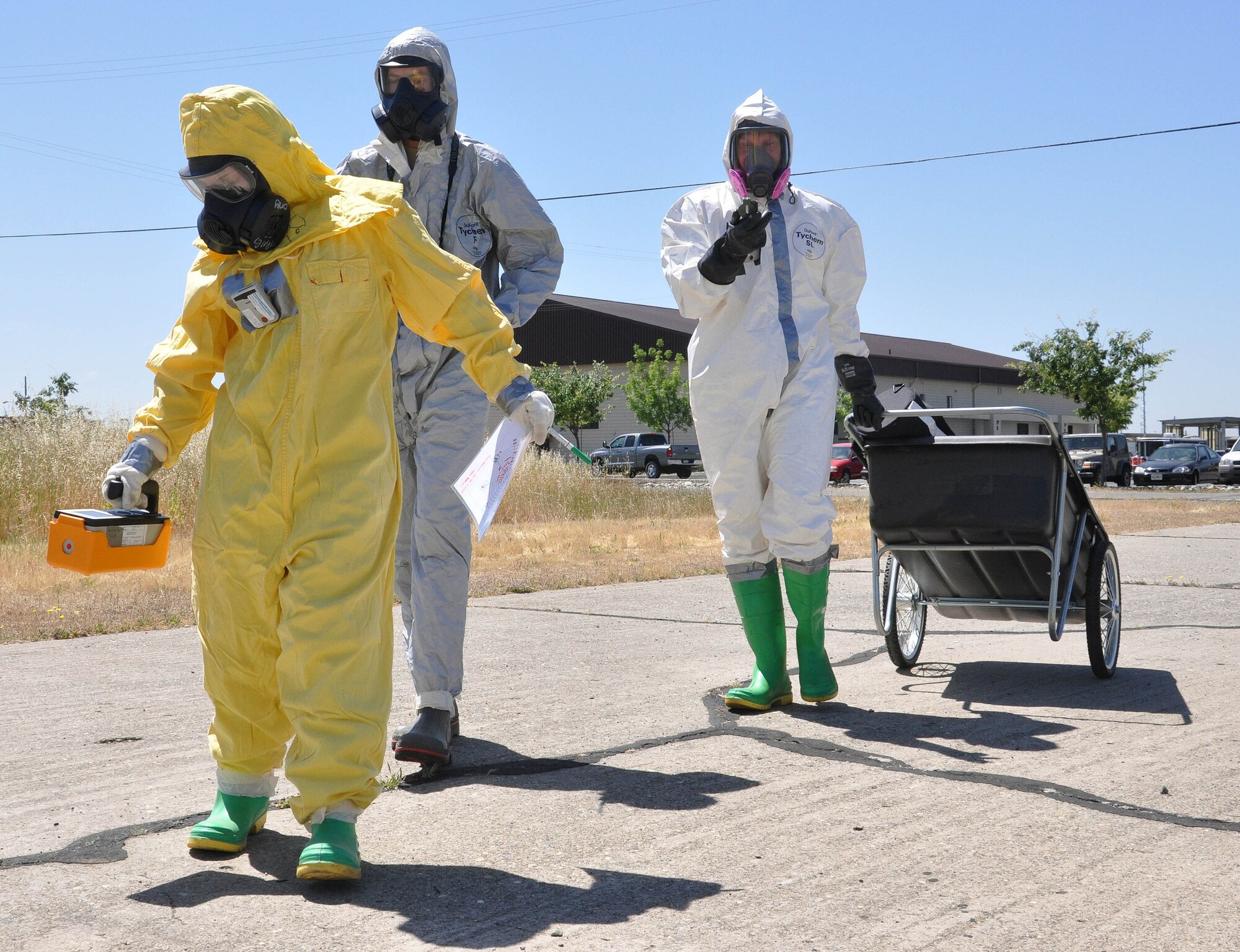 Airmen from the 940th Civil Engineer Squadron and 9th CES scan the area for nuclear radiation during a Total Force Integration exercise, May 13, near the CE compound at Beale Air Force Base, Calif. The training exercise helped prepare both reserve and active duty airmen for any contingency involving radioactive explosive devices. (U.S. Air Force Photo/ Tech. Sgt. Luke Johnson)