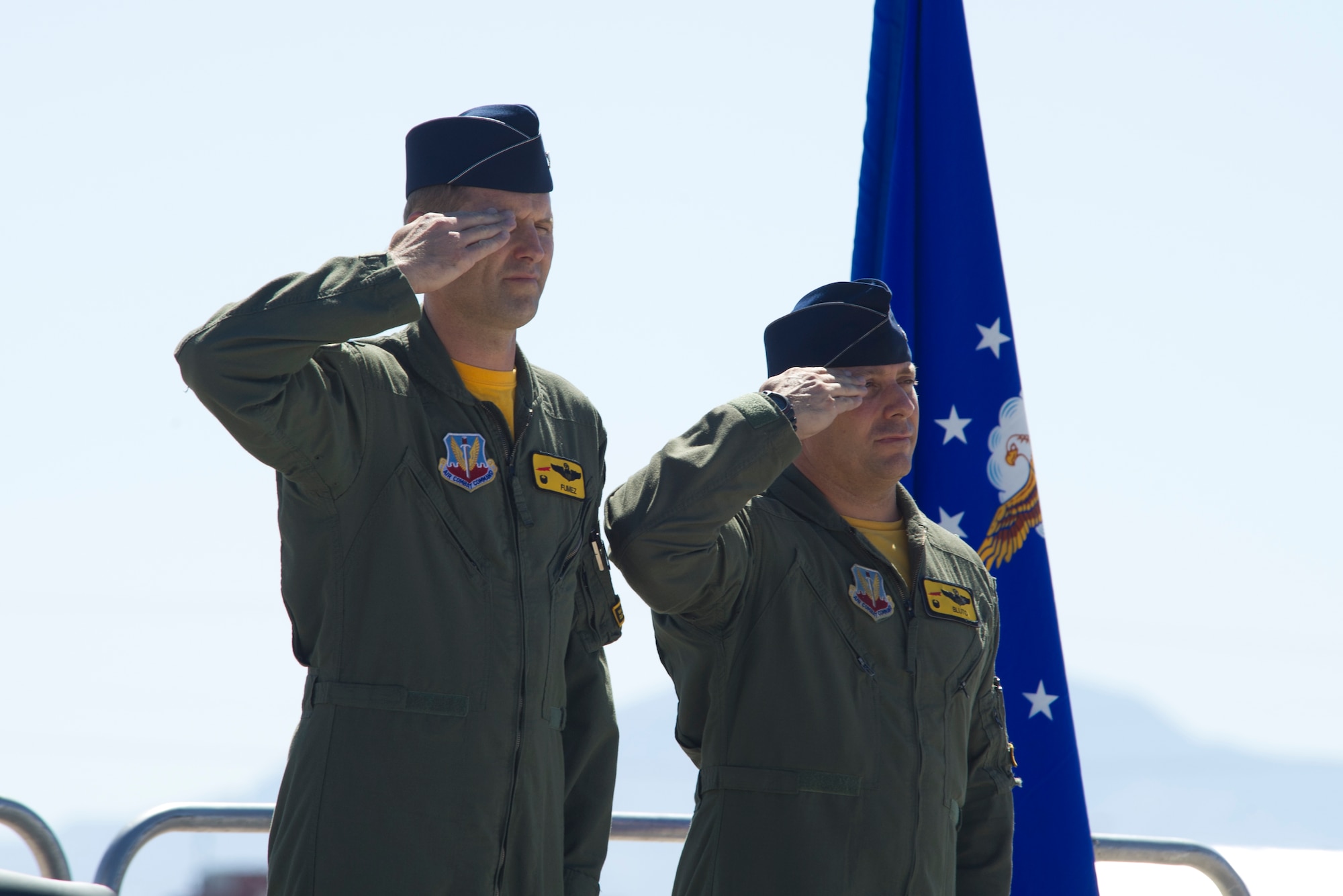 HOLLOMAN AIR FORCE BASE, N.M – Col. Kevin Huyck,  49th Operations Group commander and Lt. Col.  Craig Baker, 8th Fighter Squadron commander, render a salute during the playing of the national anthem, marking the start of the 8th FS inactivation ceremony. The 8th FS, known as the “Black Sheep,” was first activated in January 1941 and its mission and aircraft have transitioned several times to support the emerging needs of the Air Force. Starting with the P-40 Warhawk, the “Black Sheep” have led the way in fielding, flying and employing the Air Force’s newest air superiority aircraft. Currently flying the F-22 Raptor, the unit’s inactivation means that its Airman and aircraft will be relocated to other units on Holloman. The famed “Black Sheep”” patch, name, and colors will be maintained by Air Force historians for reactivation when needed. (U.S. Air Force photo by Tech Sgt. Joe Laws / Released)