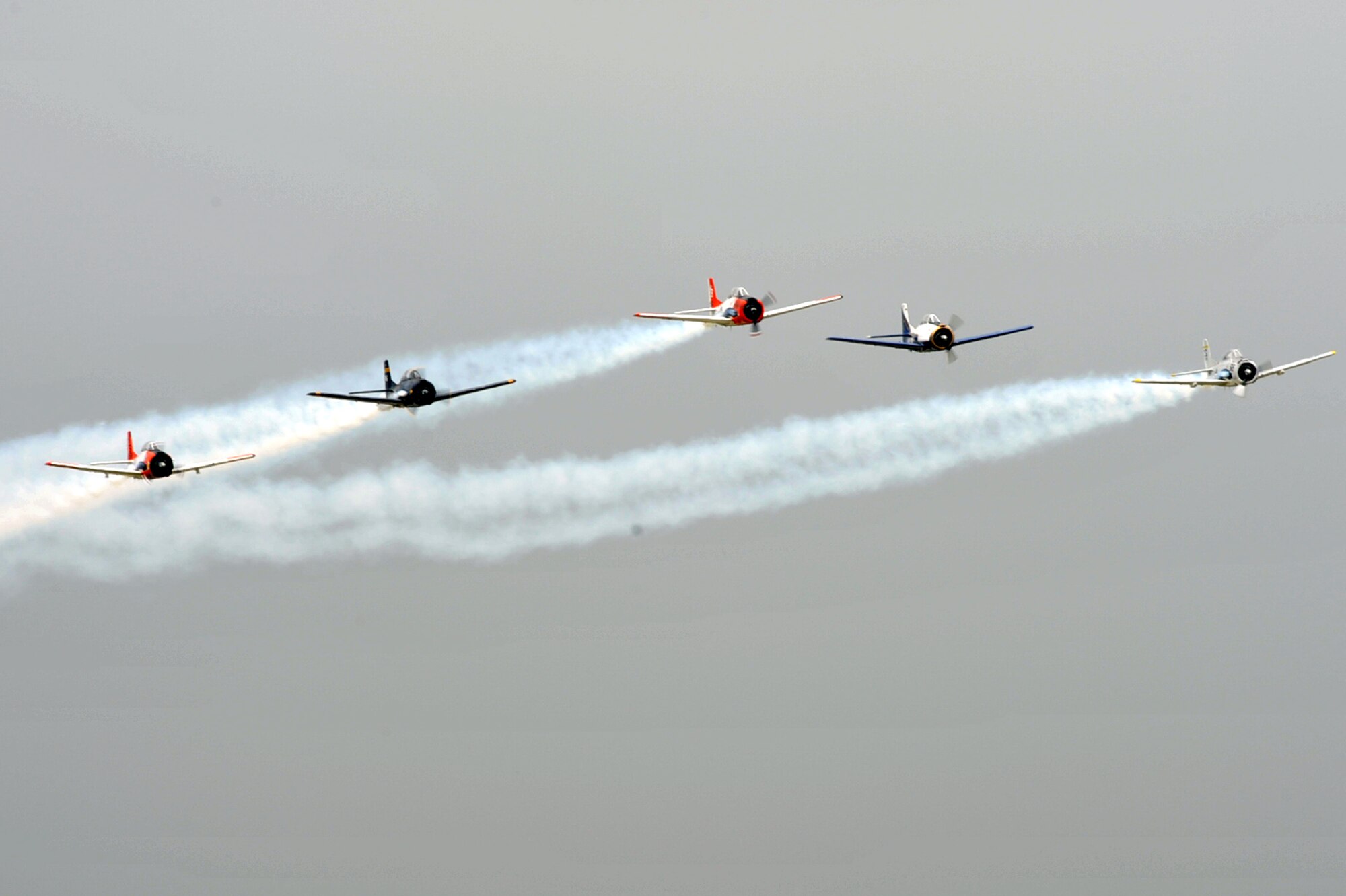 The Trojan Horsemen T-28 Warbirds Aerobatic Formation Demonstration Team performs aerial maneuvers during the AirPower over Hampton Roads open house at Langley Air Force Base, Va., May 13, 2011. The open house is a free three-day event featuring aerial demonstrations by modern and historical military aircraft and civilian performers. (U.S. Air Force photo by Airman 1st Class Camilla Griffin/RELEASED)