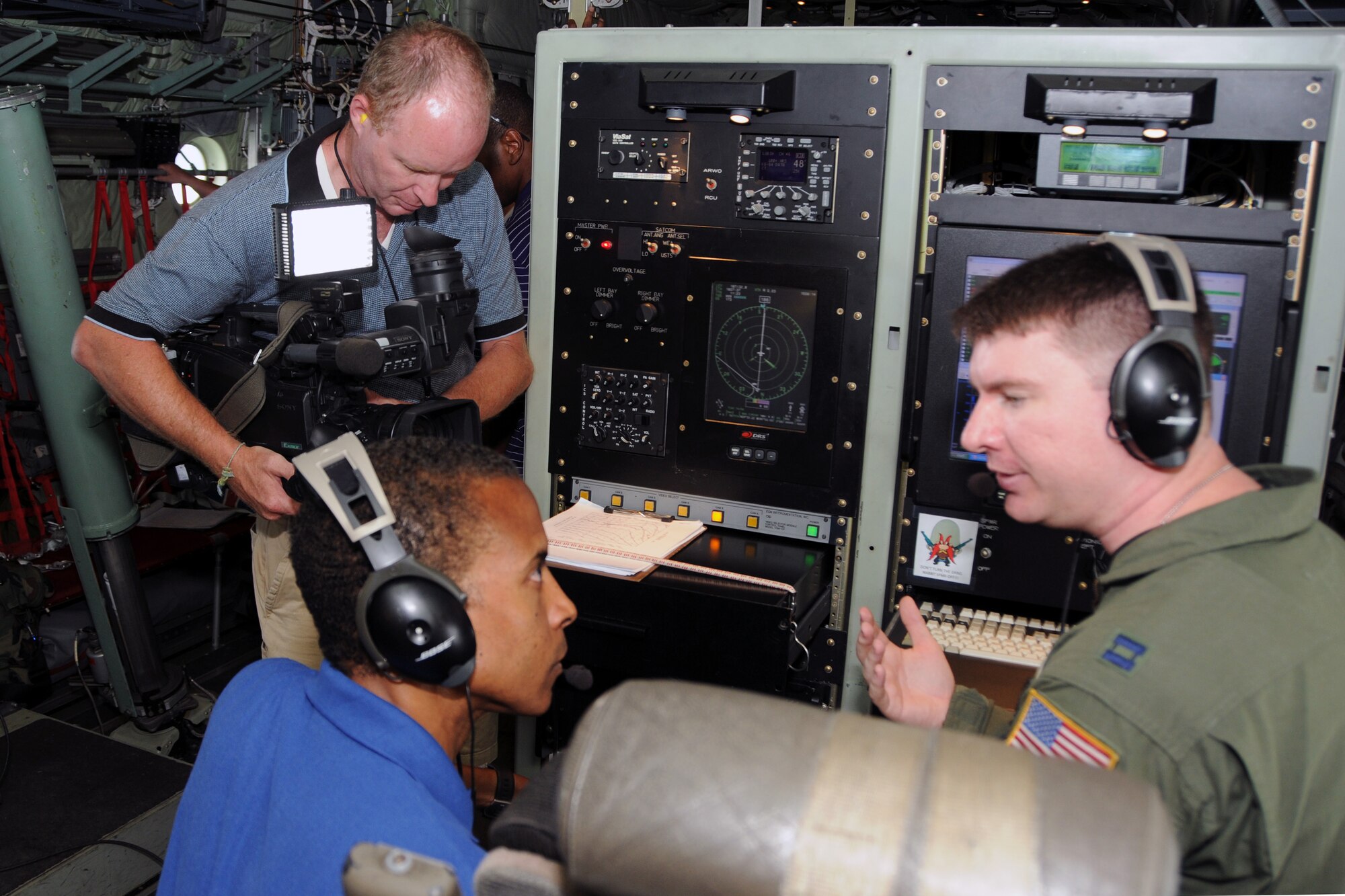 Capt. Christopher Dyke, 53rd Weather Reconnaissance Squadron weather officer, exlpains the technology behind the data collection during a storm mission to the WDSU media team, Damon Singleton and Kevin Duckworth, camera. There were 11 outlets who attended media day with the 53rd Hurricane Hunters. They were briefed on the mission and were able to accompany the aircrew on a training mission. 