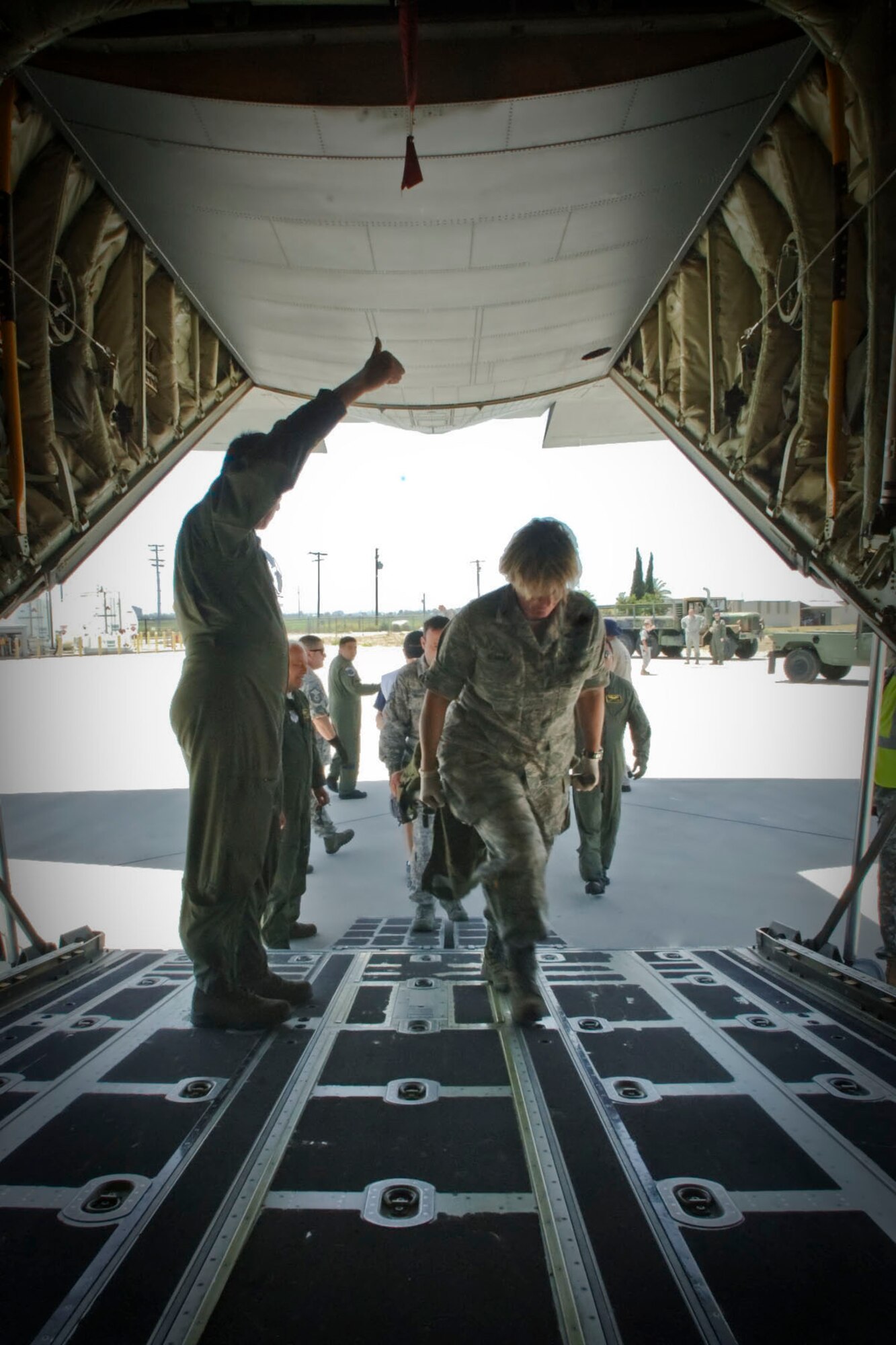 U.S. Air Force Colonel Nancy Sumner, Commander of the 146th Medical Group assists with a litter carry bringing in a victim volunteer into a C-130J where they mimic being transported during "Operation Medical Shelter," a simulated disaster training exercise on May 11, 2011 at Freedom Park in Camarillo, California. The exercise consisted of volunteers from local area hospital medical staff, law enforcement agencies, and local military state reserve.. (U.S. Air Force photo by Airman 1st Class Nicholas Carzis/Not Released)