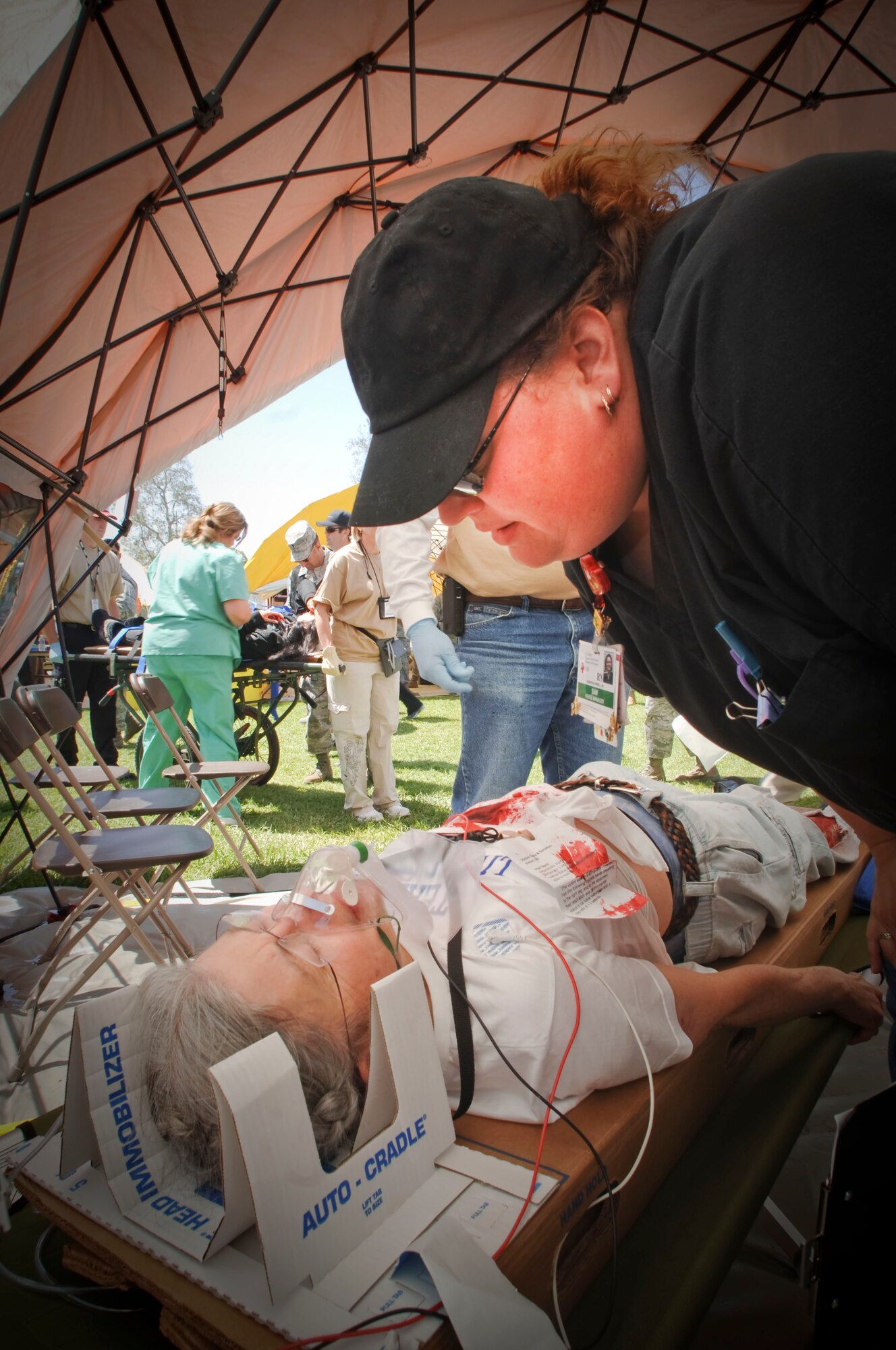 A medical volunteer assesses an acting victim volunteer?s injuries during "Operation Medical Shelter," a simulated disaster training exercise on May 11, 2011 at Freedom Park in Camarillo, California. The exercise consisted of volunteers from local area hospital medical staff, law enforcement agencies, and local military state reserve. (U.S. Air Force photo by Airman 1st Class Nicholas Carzis/Not Released)