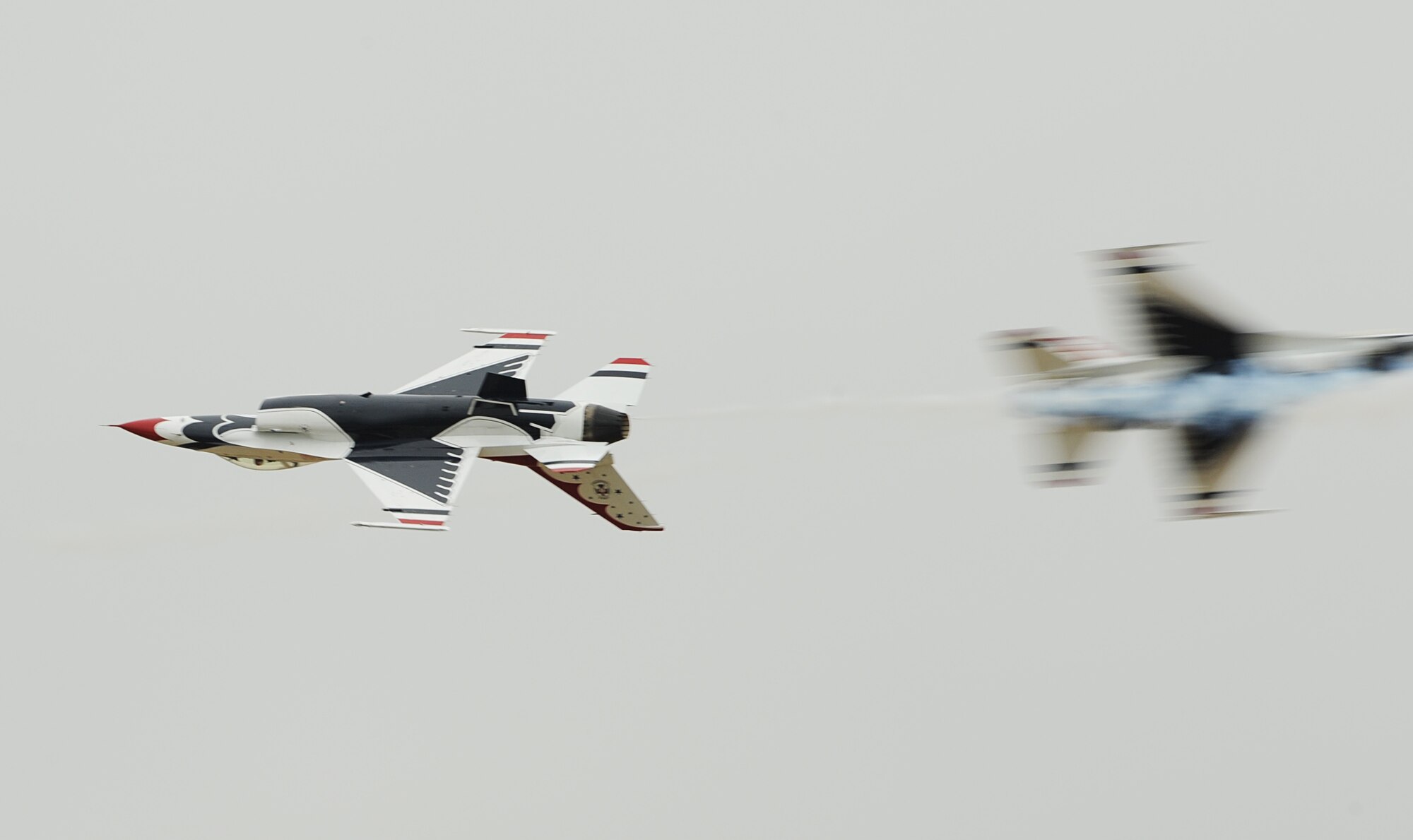 F-16 Fighting Falcon Thunderbirds perform a Crossover Break during Joint Base-Langley Eustis’ Air Power over Hampton Roads at Langley Air Force Base, Va., May 13, 2011. As Air Force ambassadors, the Thunderbirds strive to display integrity, selfless service, and excellence embodied by American Airmen. (U.S. Air Force photo/Airman 1st Class Teresa Zimmerman)(RELEASED)