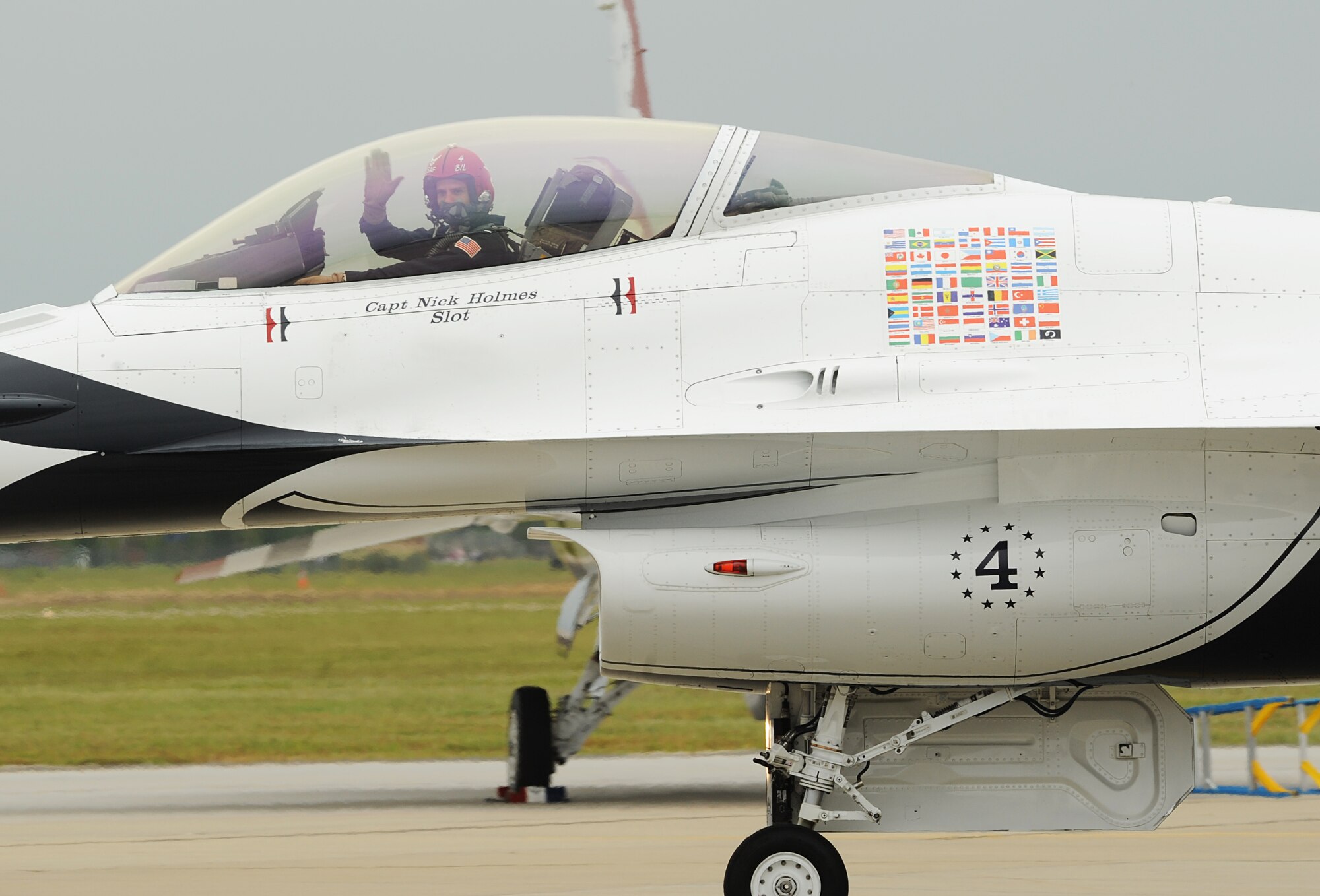Pilot for the U.S. Air Force Demonstration Squadron, the Thunderbirds, Capt. Nicholas Holmes waves to the crowd while taxiing down the runway at Langley Air Force Base, Va., May 13, 2011. The Thunderbirds headlined Joint Base Langley-Eustis’ Air Power over Hampton Roads open house with precision aerial maneuvers, demonstrating the capabilities of high performance aircraft to the Hampton Roads area. (U.S. Air Force photo/Airman 1st Class Teresa Zimmerman)(RELEASED)