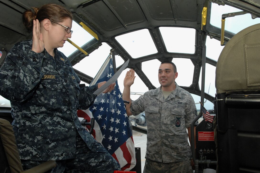 Navy Lt. Katrina Leshanski, Naval Medical Center Portsmouth medical pediatrician, gives the oath of enlistment to Staff Sgt. Jesse Zainey, 633d Civil Engineer Squadron firefighter, in a B-29 Superfortress at Langley Air Force Base, Va., May 13, 2011. Sergeant Zainey’s grandfather retired after 21 years of service as a lieutenant colonel and worked as a B-29 bombardier for several years. (U.S. Air Force photo by Airman 1st Class Racheal Watson)(RELEASED)