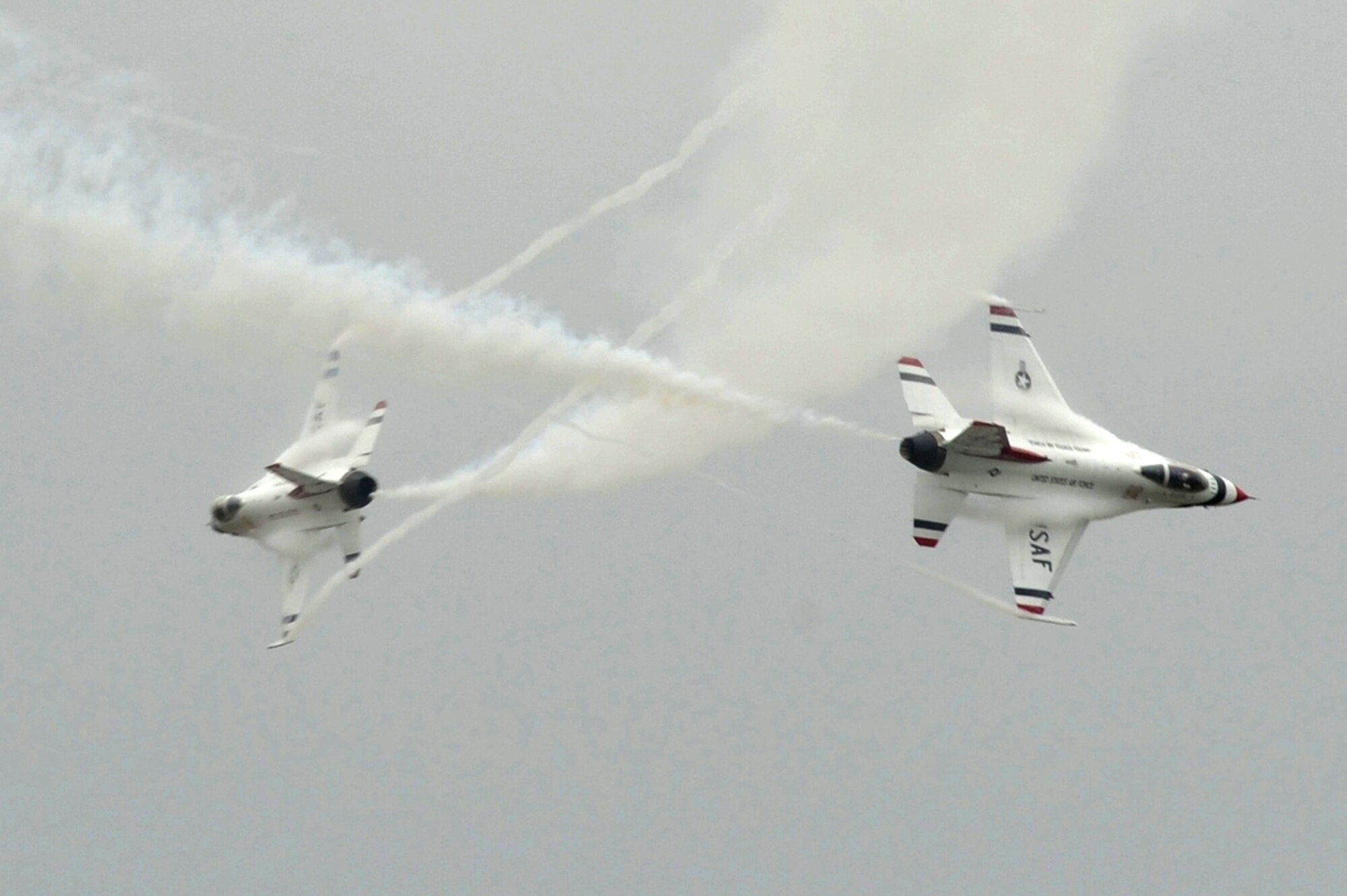 The U.S. Air Force Demonstration Squadron, the Thunderbirds, execute a crossover at Langley Air Force Base, Va., May 13, 2011. The annual AirPower over Hampton Roads open house provides a free venue in which the public can see modern and historical military aircraft and civilian performers in action. (U.S. Air Force photo by Airman 1st Class Kayla Newman)(RELEASED)