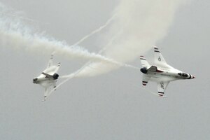The U.S. Air Force Demonstration Squadron, the Thunderbirds, execute a crossover at Langley Air Force Base, Va., May 13, 2011. The annual AirPower over Hampton Roads open house provides a free venue in which the public can see modern and historical military aircraft and civilian performers in action. (U.S. Air Force photo by Airman 1st Class Kayla Newman)(RELEASED)