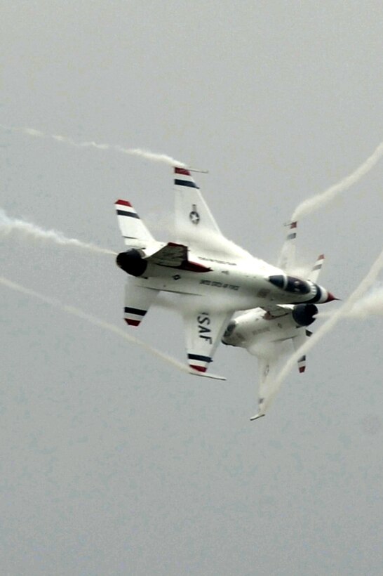 The U.S. Air Force Demonstration Squadron, the Thunderbirds, execute a crossover during an aerial demonstration at Langley Air Force Base, Va., May 13, 2011. The annual AirPower over Hampton Roads open house provides a free venue in which the public can see modern and historical military aircraft and civilian performers in action. (U.S. Air Force photo by Airman 1st Class Kayla Newman)(RELEASED)