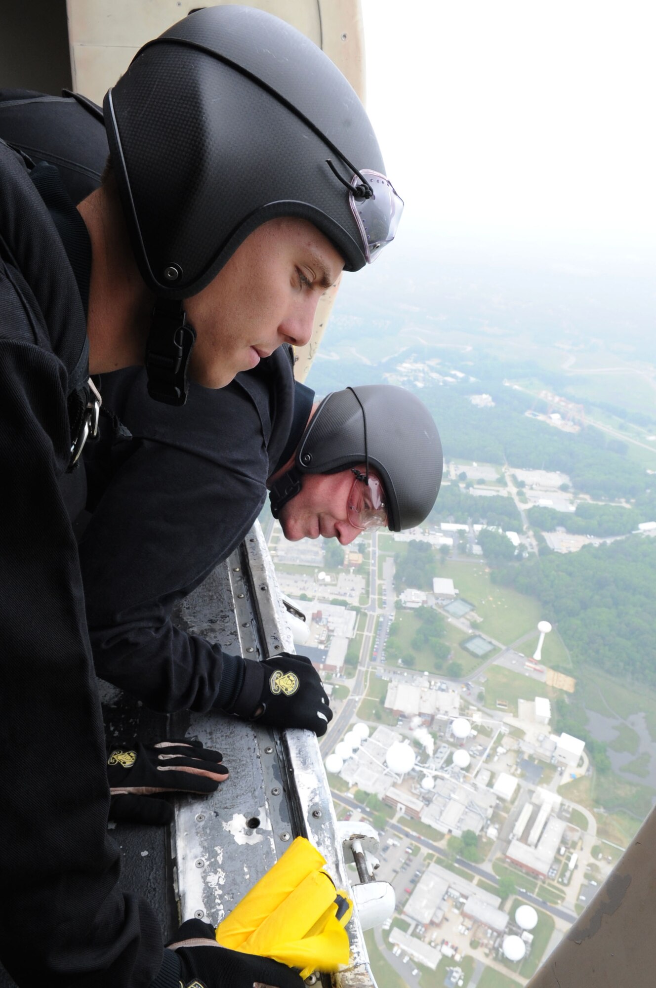 Army Spc. Jeshua Stahler and Sgt. 1st Class J.D. Berentis, U.S. Army Golden Knights Parachute Team, parachutists, survey the landing area prior to jumping at Langley Air Force Base, Va., May 13, 2011 during AirPower over Hampton Roads. The Golden Knights have been wowing audiences at air shows, competitions, and high-profile tandems for 50 years. (U.S. Air Force photo by Airman 1st Class Kayla Newman)(RELEASED)