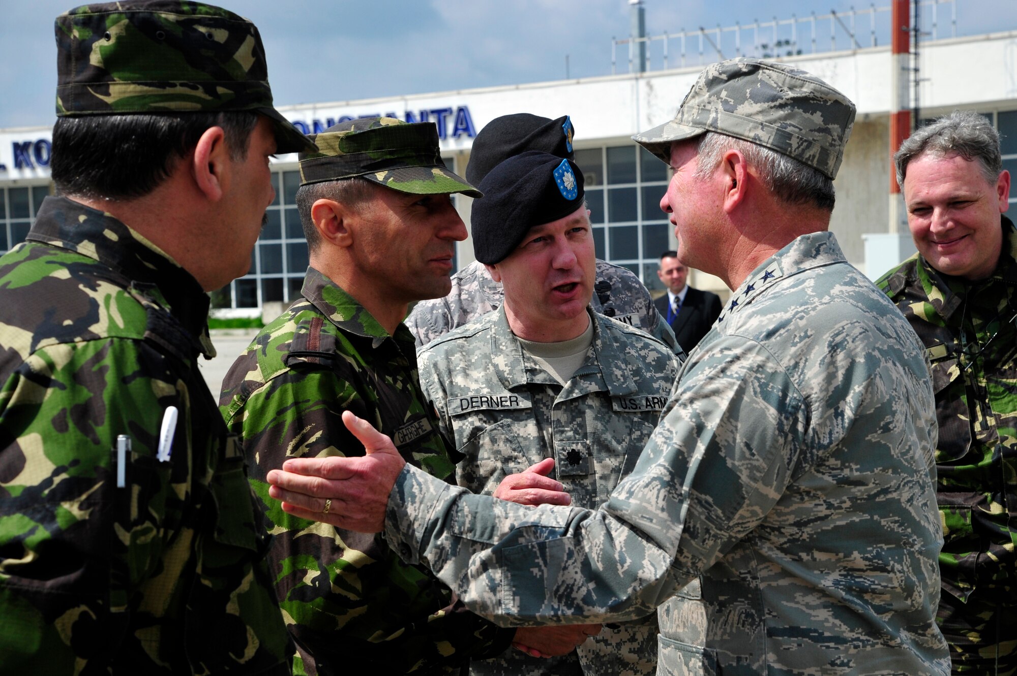 Gen. Duncan McNabb, U.S. Transportation Command commander presents a USTRANSCOM coin to Romanian land force, Maj. Gheorghe Gherghe, logistics officer during a visit at Mihail Kogalniceanu Air Base, Romania, May 12. While in
Romania, General McNabb visited both Mihail Kogalniceanu airport and the
Port of Constanta.  USTRANSCOM is evaluating the feasibility of using the
airport and seaport as a multi-modal hub for equipment flowing into and out
of the U.S. Central Command theater of operation.  (U.S. Air Force photo by
Master Sgt. Laura K. Deckman/released)