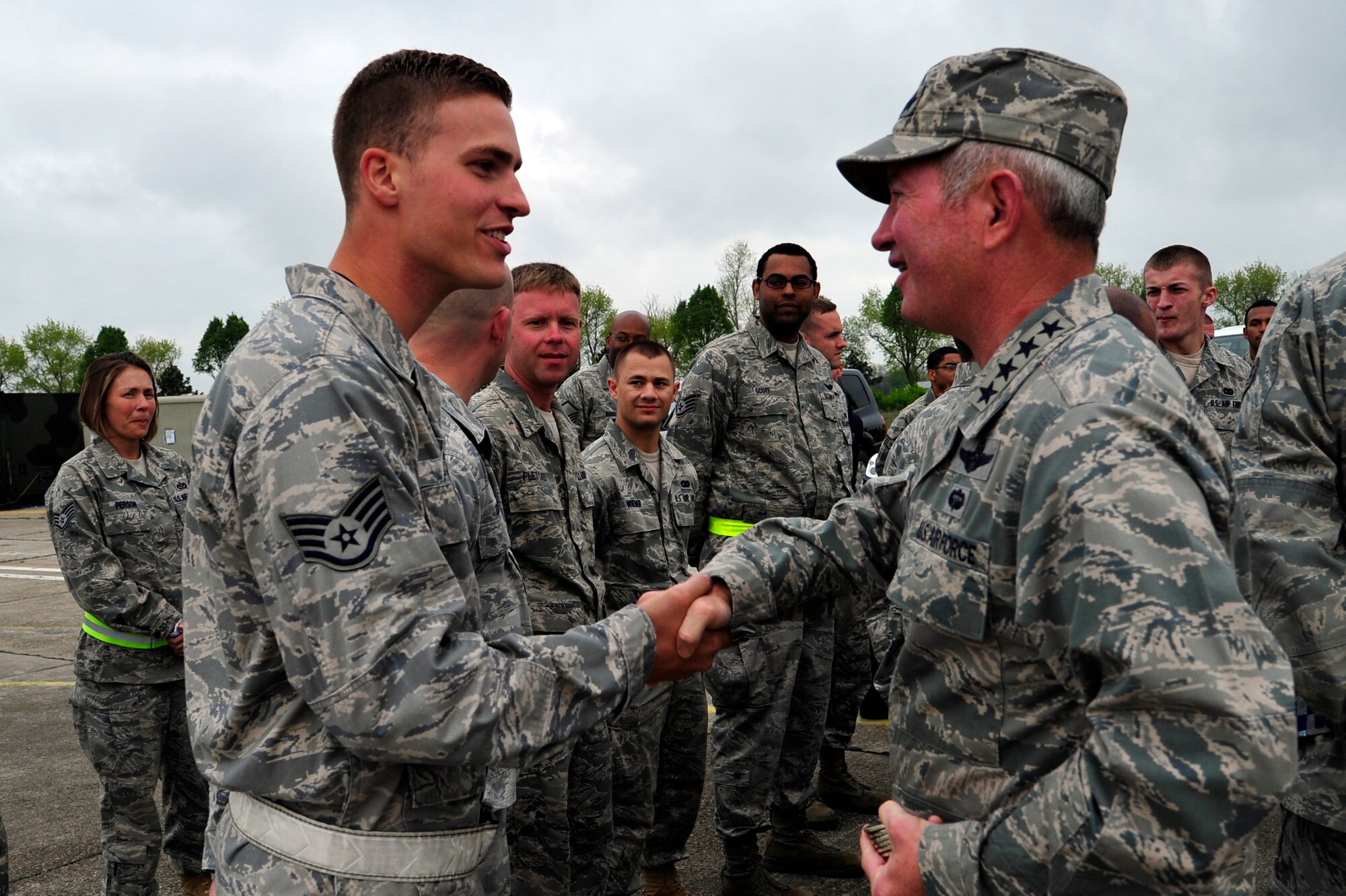 Gen. Duncan McNabb, U.S. Transportation Command commander presents a USTRANSCOM coin to Staff Sgt. Matthew Adelman, 385th Air Expeditionary Group aerospace ground equipment craftsman deployed from Charleston Air Force Base, S.C.  at Mihail Kogalniceanu Air Base, Romania, May 12.  While in Romania, General McNabb visited both Mihail Kogalniceanu airport and the Port of Constanta.  USTRANSCOM is evaluating the feasibility of using the airport and seaport as a multi-modal hub for equipment flowing into and out of the U.S. Central Command theater of operation.  (U.S. Air Force photo by
Master Sgt. Laura K. Deckman/released)