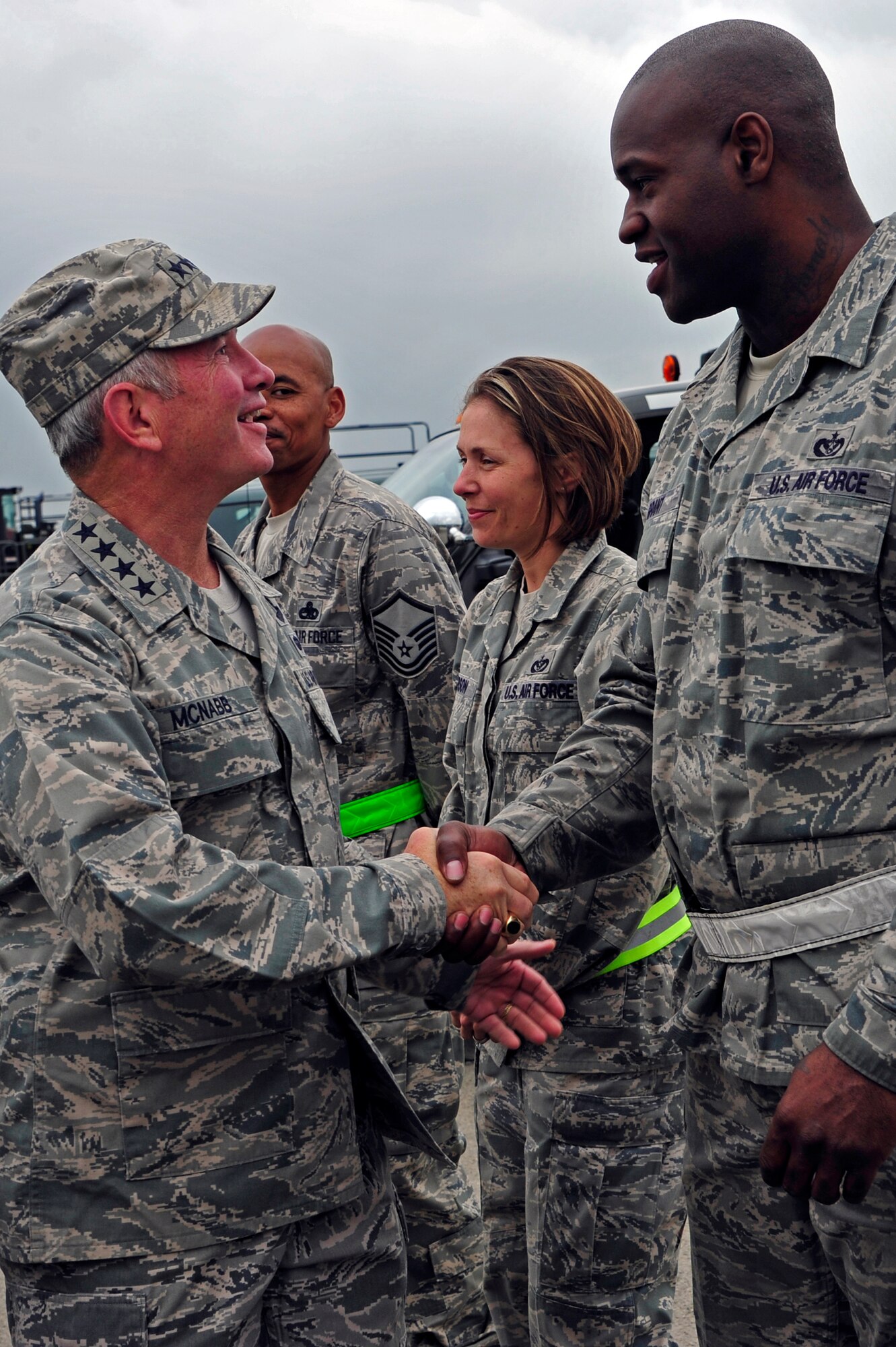 Gen. Duncan McNabb, U.S. Transportation Command commander presents a USTRANSCOM coin to Staff Sgt. Joseph Grant, 621st Contingency Response Wing power production technician at Mihail Kogalniceanu Air Base, Romania, May 12.  While in Romania, General McNabb visited both Mihail Kogalniceanu airport and the
Port of Constanta.  USTRANSCOM is evaluating the feasibility of using the
airport and seaport as a multi-modal hub for equipment flowing into and out
of the U.S. Central Command theater of operation.  (U.S. Air Force photo by
Master Sgt. Laura K. Deckman/released)
