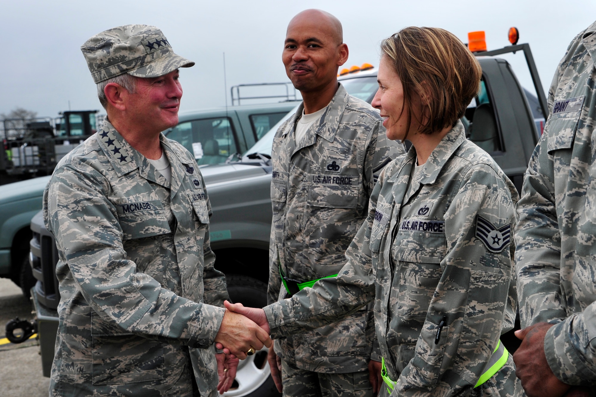 Gen. Duncan McNabb, U.S. Transportation Command commander presents a USTRANSCOM coin to Staff Sgt. Janel Person, 621st Contingency Response Wing heating, ventilation and air conditioning technician at Mihail Kogalniceanu Air Base, Romania, May 12.  While in Romania, General McNabb visited both Mihail Kogalniceanu airport and the Port of Constanta.  USTRANSCOM is evaluating the feasibility of using the airport and seaport as a multi-modal hub for equipment flowing into and out of the U.S. Central Command theater of operation.  (U.S. Air Force photo by Master Sgt. Laura K. Deckman/released)