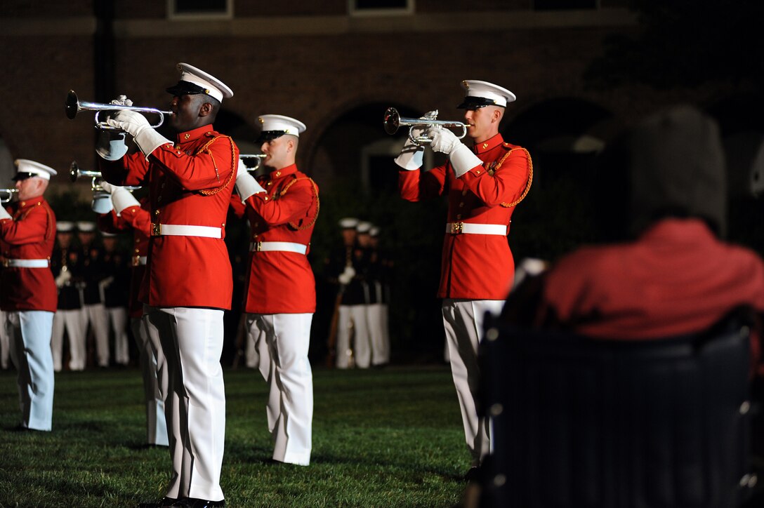 Jeff Swope, a disabled Navy veteran, watches the Marine Drum and Bugle Corps play the theme to "Pirates of the Caribbean" during an Evening Parade at Marine Barracks Washington May 13, 2011.