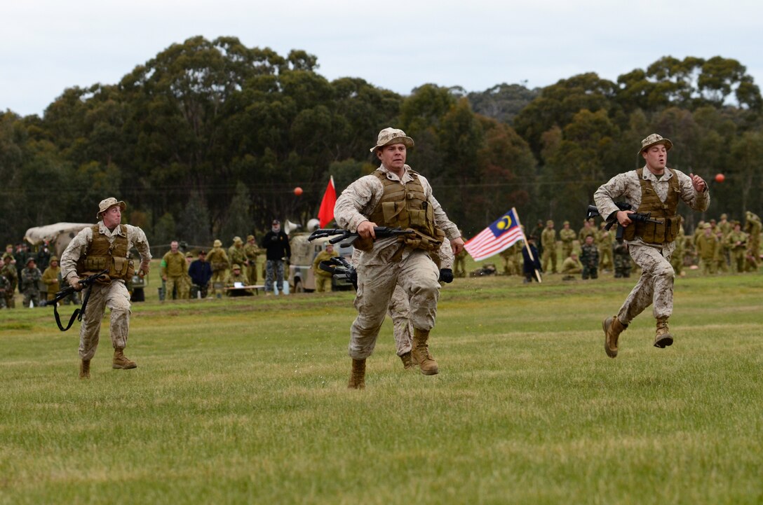 Marines with Combat Shooting Team, Weapons Training Battalion, Marine Corps Base Quantico, sprint towards the firing line here May 15 as onlookers from several nations look on during the 2011 Australian Army Skill at Arms Meeting. The meeting is an annual, international combat-marksmanship competition hosted by the Australian Army that will run through May 19.  (U.S. Marine Corps Photo by Lance Cpl. Mark W. Stroud/Released)