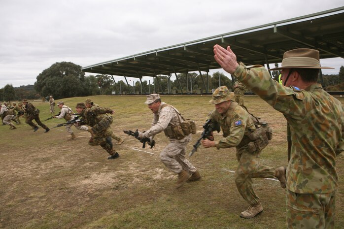 Australian Army Maj. Gen. David Morrison (right), commanding general, Forces Command, orders a bayonet charge here May 15 during the 2011 Australian Army Skill at Arms Meeting (AASAM).  The charge was carried out by Marines with Marine Shooting Detachment Australia, New Zealand Army soldiers and Australian Army soldiers.  The week-long meeting pit military representatives from partner nations in competition in a series of grueling combat marksmanship events. Represented nations include Canada, France (French Forces New Caledonia), Indonesia, Timor Leste, Brunei, Netherlands, U.S., Papua New Guinea, New Zealand, Singapore, Malaysia, Thailand as well as a contingent of Japanese observers. (U.S. Marine Corps Photo by Lance Cpl. Mark W. Stroud/Released)