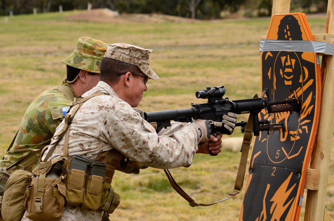 Staff Sgt. Edward Ortiz, staff noncommissioned officer-in-charge, Combat Shooting Team, Weapons Training Battalion, Marine Corps Base Quantico, bayonets a target simultaneously with an Australian soldier May 15, during the 2011 Australian Army Skill at Arms Meeting. The week-long meeting pit military representatives from partner nations in competition in a series of grueling combat marksmanship events. Represented nations include Canada, France (French Forces New Caledonia), Indonesia, Timor Leste, Brunei, Netherlands, U.S., Papua New Guinea, New Zealand, Singapore, Malaysia, Thailand as well as a contingent of Japanese observers. (U.S. Marine Corps Photo by Lance Cpl. Mark W. Stroud/Released)