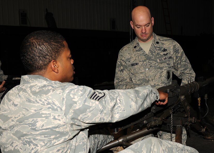 KUNSAN AIR BASE, Republic of Korea -- Lt. Col. Mark Anarumo, 8th Security Forces Squadron commander, gives Staff Sgt. Clarence Douglas, 8th Medical Group, information about the .50 Caliber Machine Gun here May 13. Medical technicians received simulator orientation and briefings at Big Coyote as part of National Nurses week. (U.S. Air Force photo/Senior Airman Ciara Wymbs)