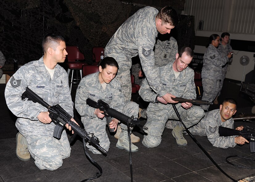 KUNSAN AIR BASE, Republic of Korea -- Tech. Sgt. Brian Redenbaugh, 8th Security Forces Squadron, assists medical technicians from the 8th Medical Group before going through simulator orientation here May 13. Medical technicians received simulator orientation and briefings at Big Coyote as part of National Nurses week. (U.S. Air Force photo/Senior Airman Ciara Wymbs)