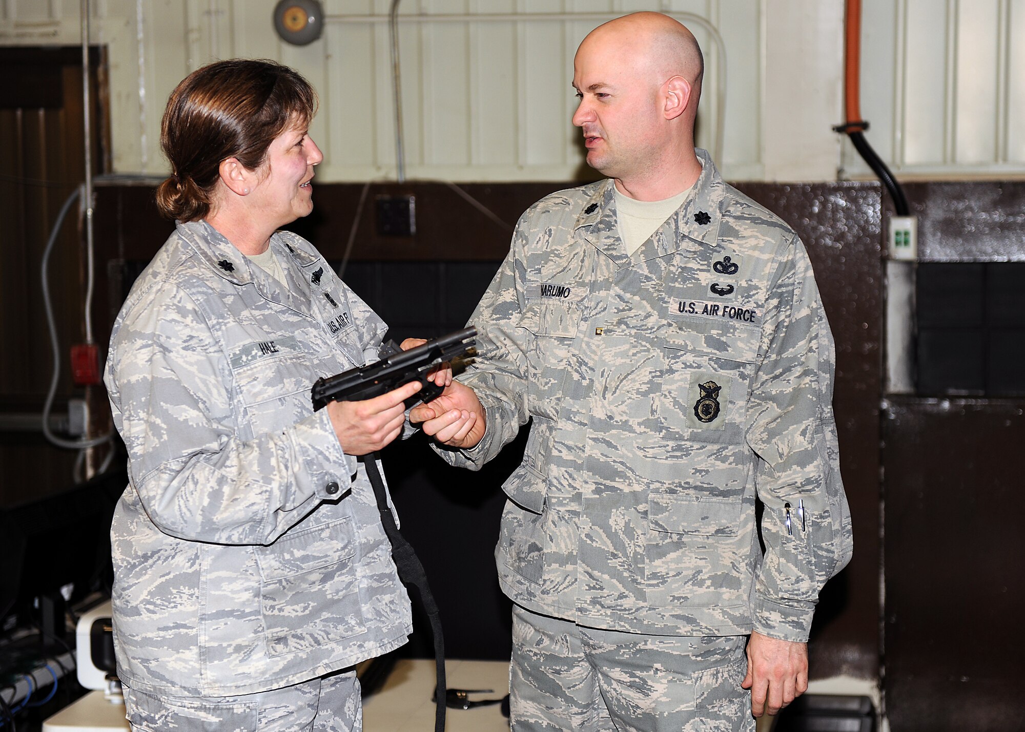 KUNSAN AIR BASE, Republic of Korea -- Lt. Col. Mark Anarumo, 8th Security Forces Squadron commander, briefs Lt. Col. Evelyn Hale, 8th Medical Group chief nurse, on the M-9 pistol at simulator orientation here May 13. Medical technicians received simulator orientation and briefings at Big Coyote as part of National Nurses week. (U.S. Air Force photo/Senior Airman Ciara Wymbs)