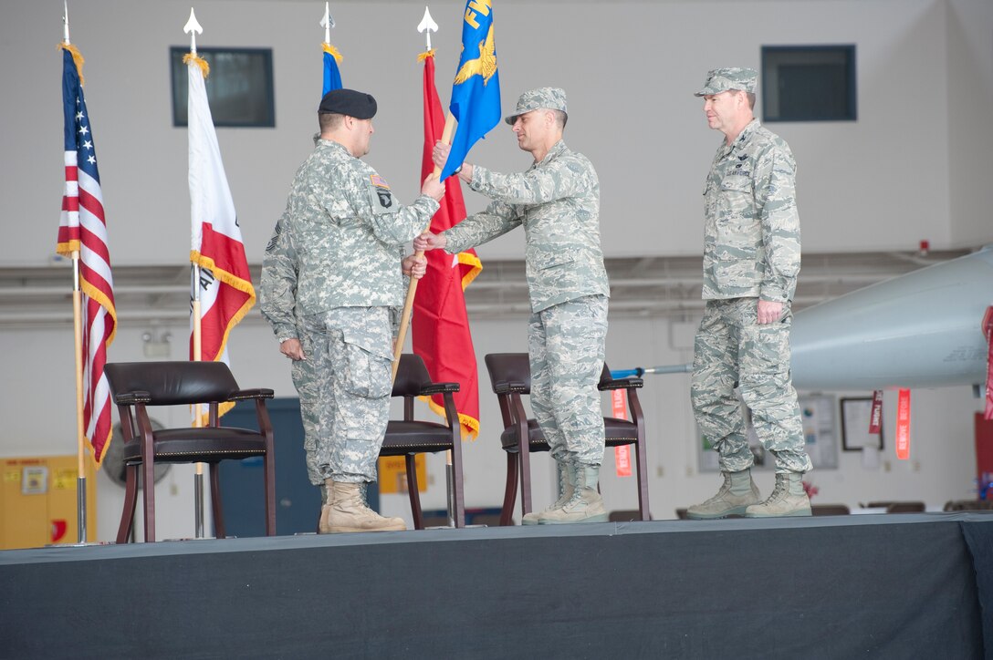 Brig. Gen. David S. Baldwin, The Adjutant General, California National Guard, passes the unit's guidon flag to the new commander, Col. Sami D. Said during a recent Change of Command Ceremony held in Fresno, Calif. on May 14, 2011.  The ceremony allows the unit to witness their new leader assume his dutiful position as the Wing Commander.  (U.S. Air Force photo by Master Sgt. David Loeffler/released)