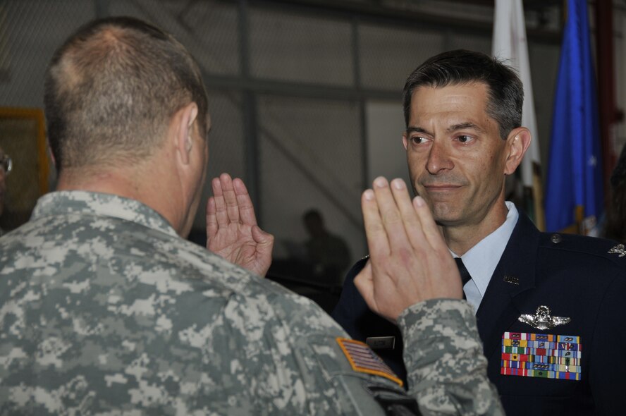 Brig. Gen. David S. Baldwin, The Adjutant General of the California National Guard, administers the oath of office to Col. Steven J. Butow, 129th Rescue Wing Vice Commander, May 14, 2011, at Moffett Federal Airfield, Calif. Colonel Butow was promoted during General Baldwin's visit to the 129th Rescue Wing. (Air National Guard photo by Staff Sgt. Kim Ramirez)