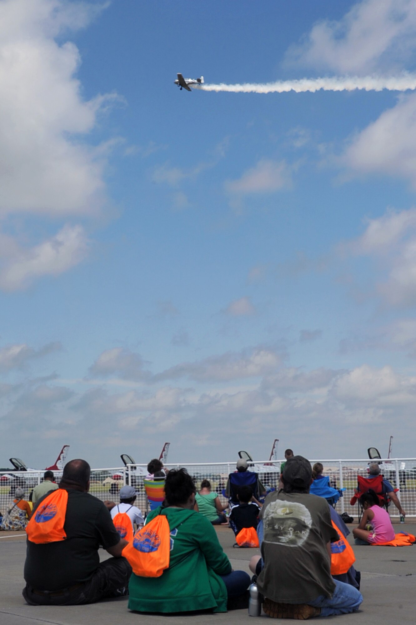 Spectators watch an aerial demonstration during the AirPower over Hampton Roads open house at Langley Air Force Base, Va., May 15, 2011. The open house educates the public on past and present military aerial capabilities, increases recruiting and shows appreciation to the local community. (U.S. Air Force photo by Airman 1st Class Camilla Griffin/RELEASED)