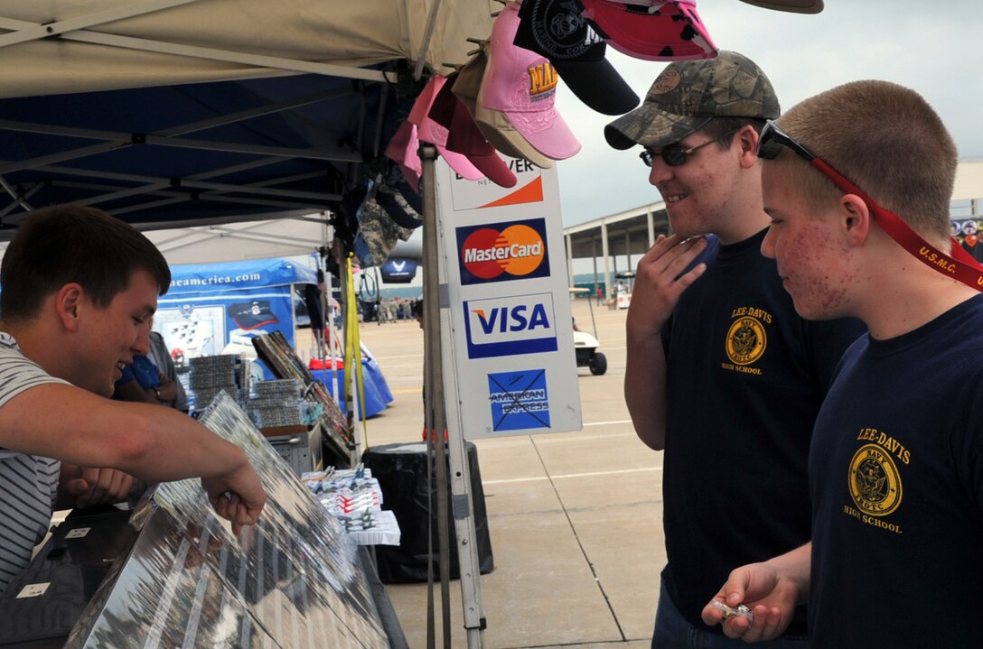Airman Robert Baldwin, 27th Aircraft Maintenance Unit avionics specialist, shows pins to Jordan Flamnia and Koty Louis, Junior Reserve Officers’ Training Corps members, during the AirPower over Hampton Roads open house at Langley Air Force Base, Va., May 15, 2011. The open house educates the public on past and present military aerial capabilities, increases recruiting and shows appreciation to the local community. (U.S. Air Force photo by Airman 1st Class Camilla Griffin/RELEASED)