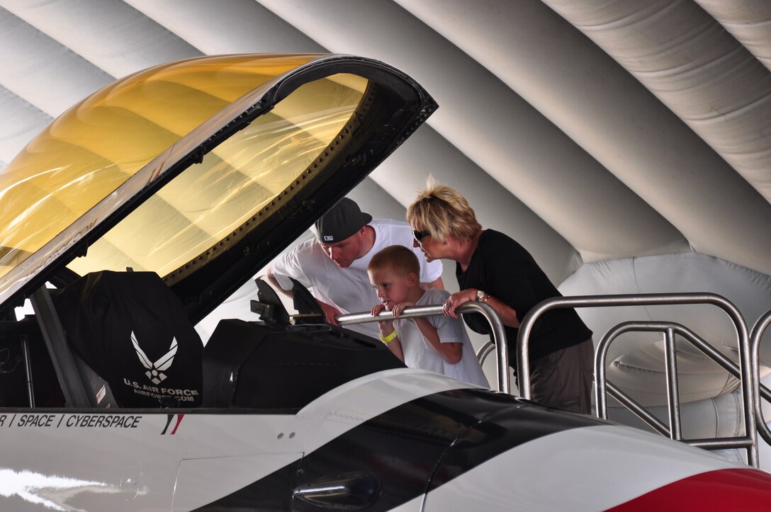 Michael, Craig and Christi Buckingham explore the inside of a Thunderbird F-16 on display at the Air Power over Hampton Roads open house at Langley Air Force Base, Va., May 14, 2011. The Joint Base Langley-Eustis open house is a free three-day event featuring a variety of aerial demonstrations, including the United States Air Force Demonstration Squadron, The Thunderbirds. (U.S. Air Force photo by Senior Airman Jonathan Muller)(RELEASED)