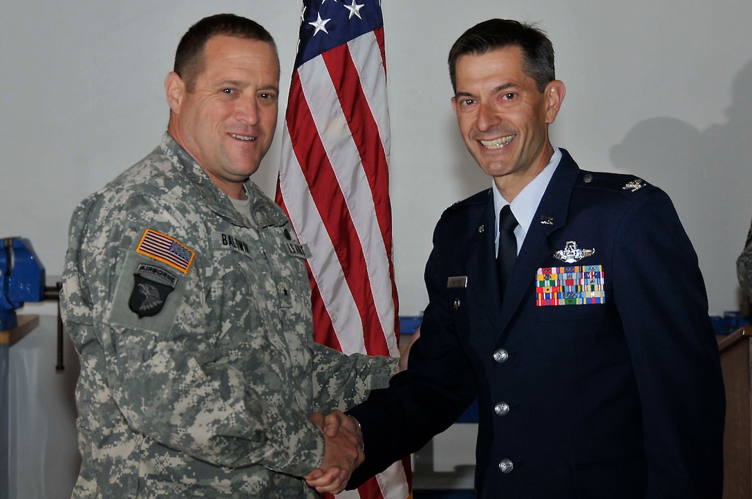 Brig. Gen. David S. Baldwin (left), The Adjutant General of the California National Guard, shakes hands with Col. Steven J. Butow, 129th Rescue Wing Vice Commander, May 14, 2011, at Moffett Federal Airfield, Calif. Colonel Butow was promoted during General Baldwin's visit to the 129th Rescue Wing. (Air National Guard photo by Staff Sgt. Kim Ramirez)