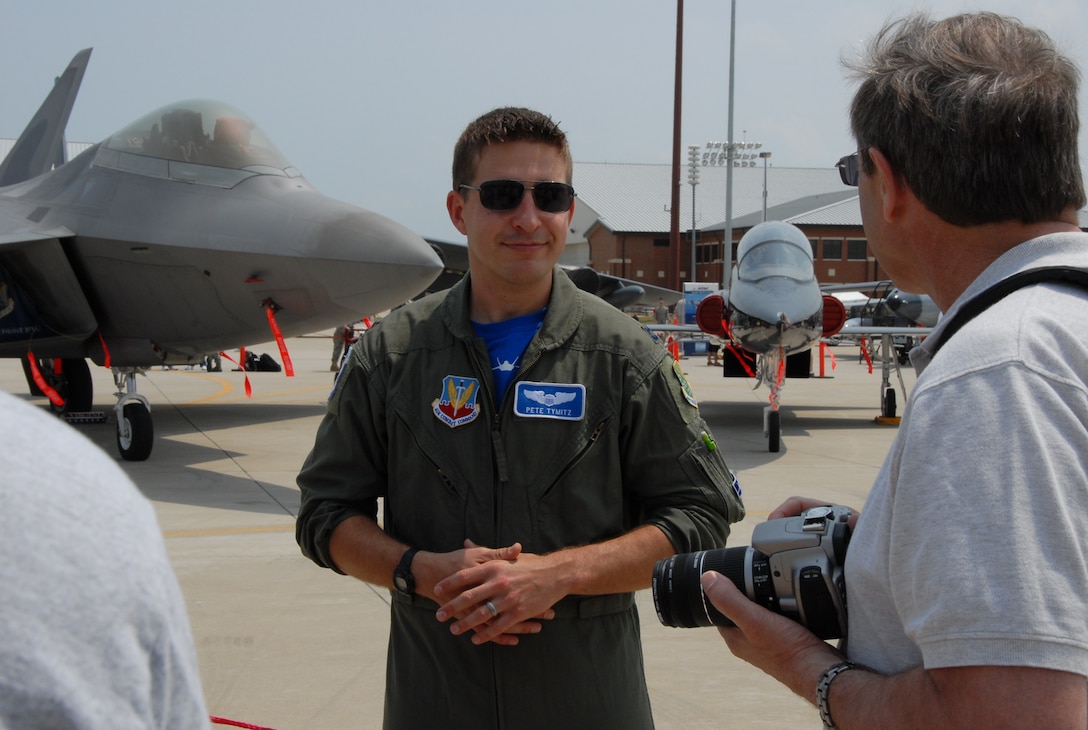 Capt. Pete Tymitz, 94th Fighter Squadron F-22 Raptor pilot, talks about the aircraft with air show attendees at Langley Air Force Base Va., May 14, 2011.  The annual AirPower over Hampton Roads open house provides a free venue in which the public can see modern and historical military aircraft and civilian performers in action. (U.S. Air Force photo by Master Sgt. Carlos J. Claudio)(RELEASED)