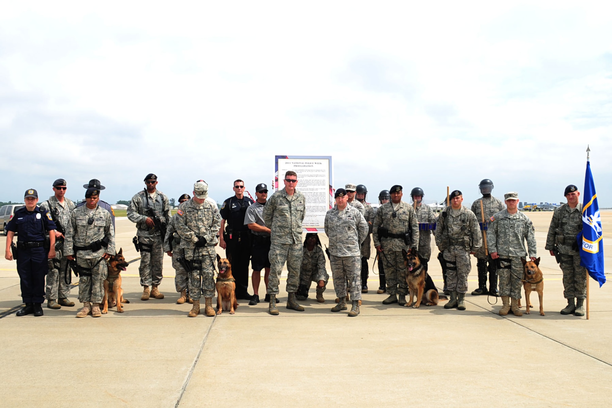 Law enforcement personnel of the Hampton Roads area celebrate the kickoff of National Police Week with the signing of the proclamation by Col. Donald Kirkland, 633d Air Base Wing commander, at Langley Air Force Base, Va., May 15, 2011. National police week is an annual event held to honor all those who defend, military and civilian. (U.S. Air Force photo by Staff Sgt. Ashley Hawkins)(RELEASED)