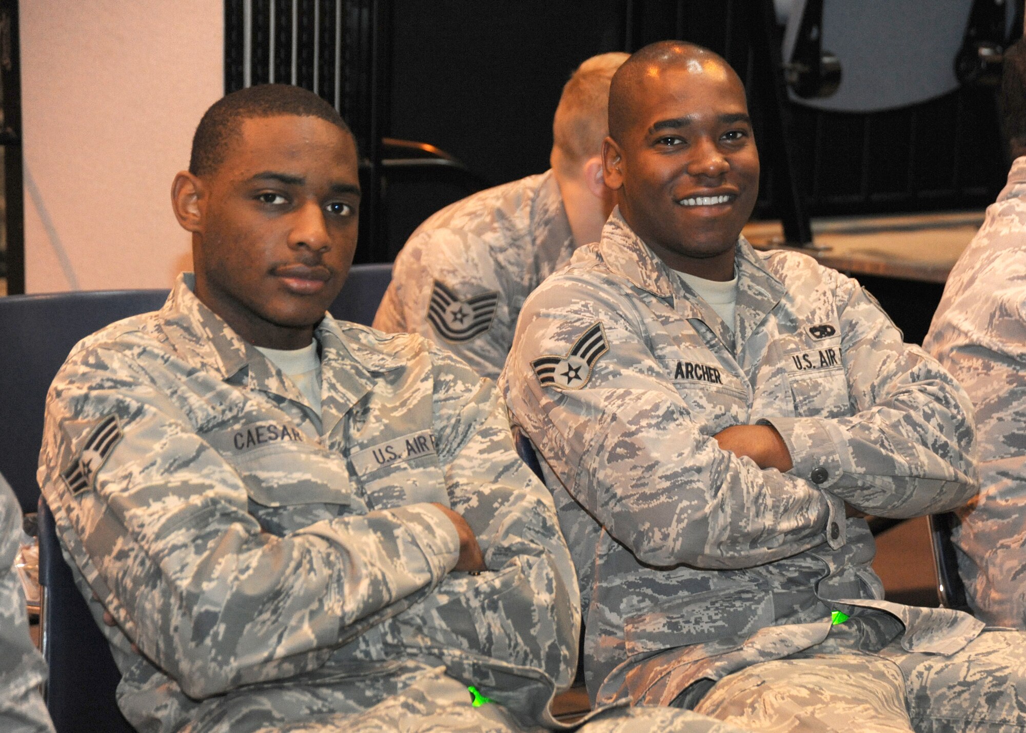 After completing the pre-deployment line Senior Airman Joel Caeser (left) and Senior Airman Sean Archer, with the 440 AW Maintenance Squadron, wait for their chalk to be called to the bus that will take them to their aircraft. For these Airman it is their first time deploying to the AOR and they made it very clear that they are excited and will bring a positive can do attitude to the fight. ( U.S. Air Force photo by Master Sgt. Kevin Brody)