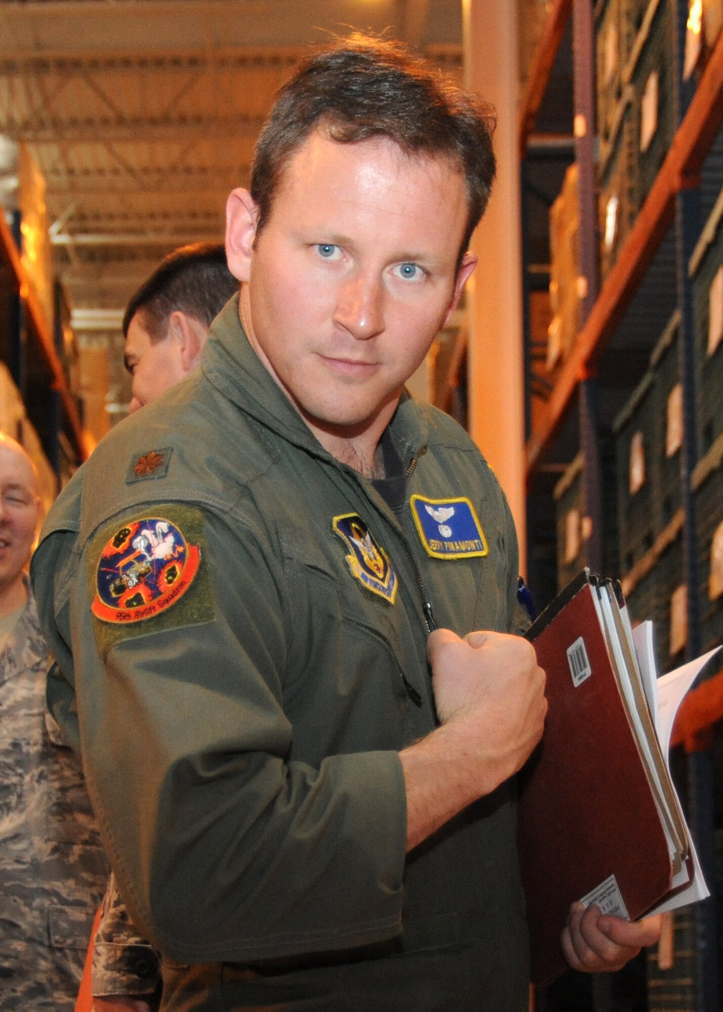 After completing the pre-deployment line, Maj. Jerry Pinamonti, a 95th Airlift Squadron pilot for the 440th Airlift WIng, Pope Field, North Carolina, displays his squadron patch ready for the missions in the AOR. Major Pinamonti was excited about going on this particular mission."I have been to the AOR before, but this mission with its variety of sorties gives  us the opportunity to fly real world missions." (U.S. Air Force photo by Master Sgt. Kevin Brody)