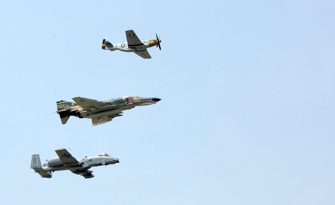 The Air Force Heritage Flight performs a fly by during the AirPower over Hampton Roads open house at Langley Air Force Base, Va., May 14, 2011. The U.S. Air Force Heritage Flight program presents the evolution of U.S. Air Force air power by flying today's state-of-the-art fighter aircraft in close formation with vintage fighter aircraft. (U.S. Air Force photo by Staff Sgt. Dana Hill)(RELEASED)