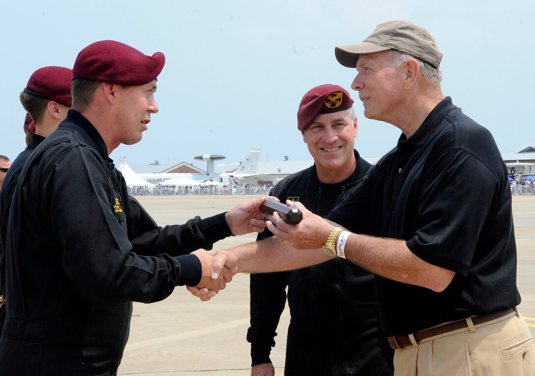 U.S. Army Staff Sgt. Tom Dunning, U.S. Army Golden Knights Parachute Team parachutist, presents a baton to Richard Atlee during the AirPower over Hampton Roads open house at Langley Air Force Base, Va., May 14, 2011. Mr. Atlee was horned as a distinguished guest and presented the baton by the Golden Knights. (U.S. Air Force photo by Staff Sgt. Dana Hill)(RELEASED)
