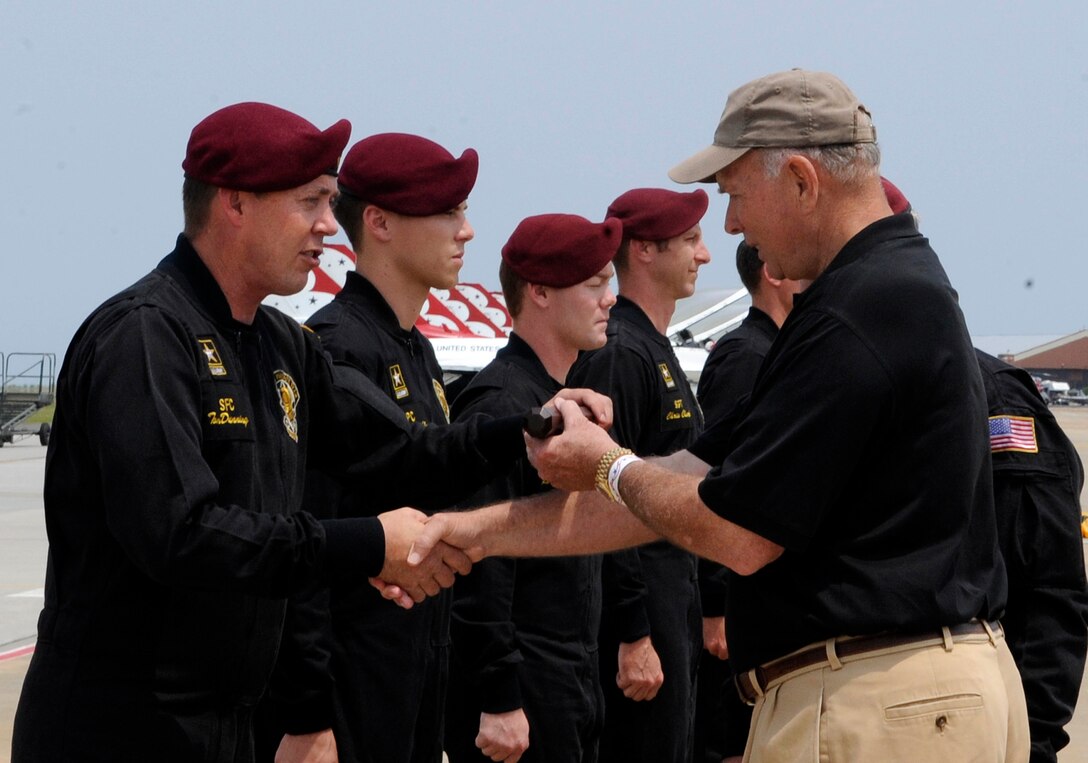 U.S. Army Staff Sgt. Tom Dunning, U.S. Army Golden Knights Parachute Team parachutist, presents a baton to Richard Atlee during the AirPower over Hampton Roads open house at Langley Air Force Base, Va., May 14, 2011. Mr. Atlee was horned as a distinguished guest and presented the baton by the Golden Knights. (U.S. Air Force photo by Staff Sgt. Dana Hill)(RELEASED)
