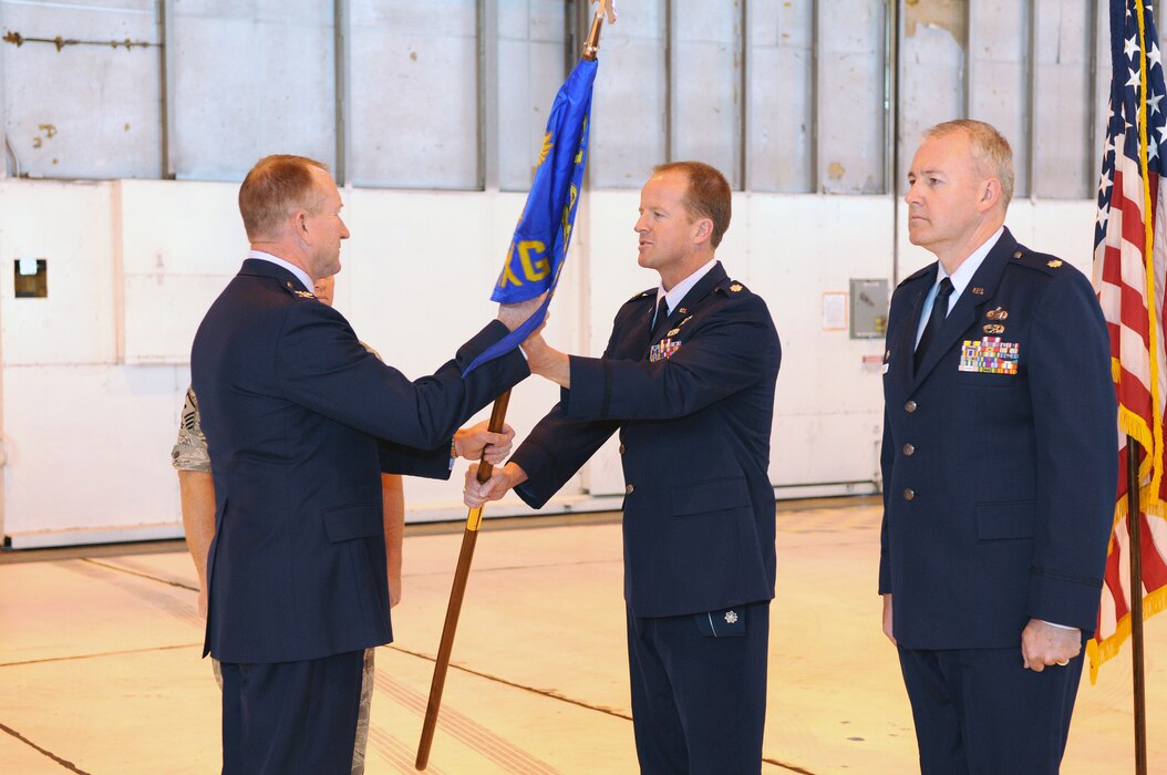 Col. Samuel Ramsay, 151st Air Refueling Wing commander, takes the 151st Maintenance Group flag from outgoing commander Lt. Col Nate C. Nelson to present to the incoming commander, Lt. Col David P. Osborne, during a Change of Command ceremony May 15, 2011. Colonel Osborne took command of the 151st MXG and its approximately 350 Airmen. U.S. Air Force photo by Tech. Sgt. Jeremy Stegall (Released)