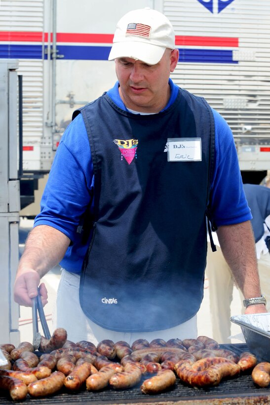 Senior Master Sgt. Eric Krentz, Headquarters Air Combat Command functional area manager, grills brats during the AirPower over Hampton Roads open house at Langley Air Force Base, Va., May 14, 2011. The Joint Base Langley-Eustis open house helps to educate the public about Air Force capabilities and shows appreciation to the local community. (U.S. Air Force photo by Staff Sgt. Ashley Hawkins)(RELEASED)