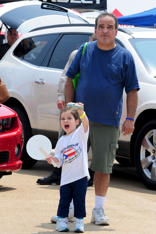 Madison Smith, two-year old daughter of Hampton, Va. resident Frank Smith, watches an aerial demonstration during the AirPower over Hampton Roads open house at Langley Air Force Base, Va., May 14, 2011. The open house provides a free venue in which the public can see modern and historical military aircraft and civilian performers in action. (U.S. Air Force photo by Staff Sgt. Ashley Hawkins)(RELEASED)