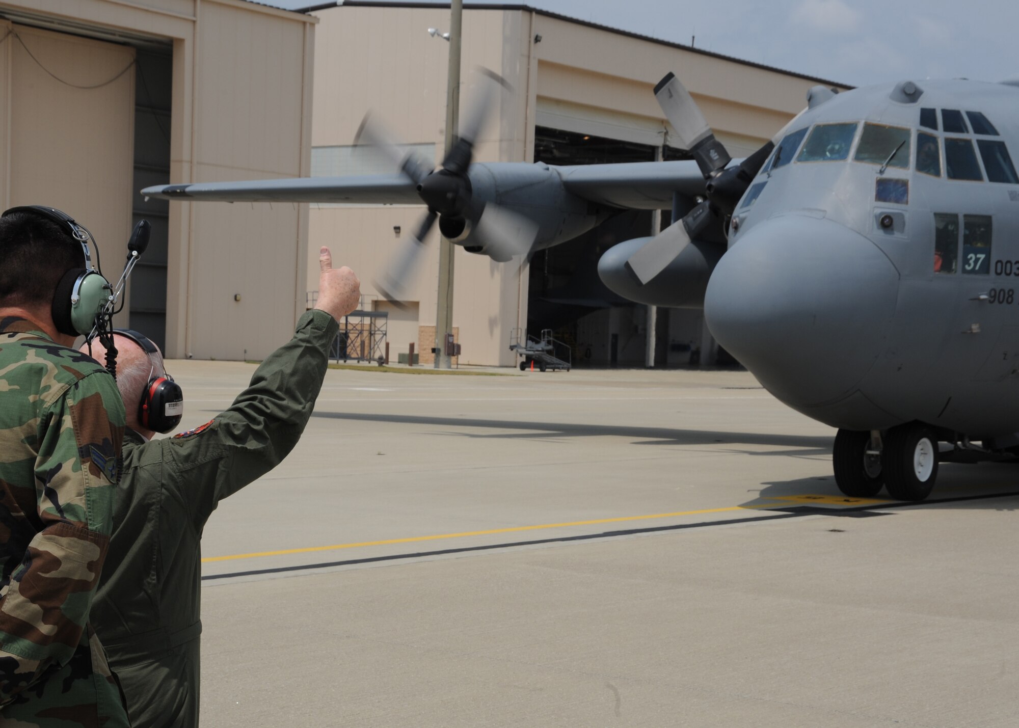 Steven Meyer, a World War II veteran, gives the "thumbs up" as he fulfills a lifelong dream to marshall a C-130 into its parking spot on  Pope Field, N.C. flighline, on May 13, 2011.  Meyer served as an Army combat engineer in the European Theater of Operations assisting in the planning of the D-Day invasion at Normandy, he said.  The event was coordinated through Jeremy Bloom’s Wish of a Lifetime foundation, Brookdale Senior Living and the Airmen of the 440th Airlift Wing.  “This is beyond my wildest dreams,” said Meyer.  “My son and grandson are here, and I am sure they will get as much of a kick out of this as I am.  I am extremely grateful.”  (U.S. Air Force photo by Staff Sgt. Peter R. Miller)