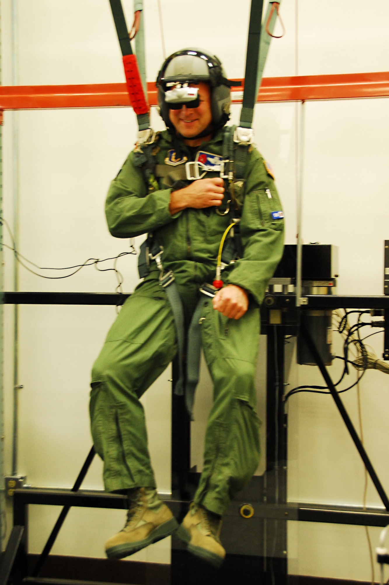 Maj. Jim Hittermen, 53rd Weather Reconnaissance Squadron pilot, hangs from the Virtual Reality Parachute Simulator during a training class for 403rd Wing aircrew members. This is an annual training that is conducted that helps save the Air Force money and keeps members current on parachute survival. (U.S. Air Force photo by Staff Sgt. Tabitha Dupas)